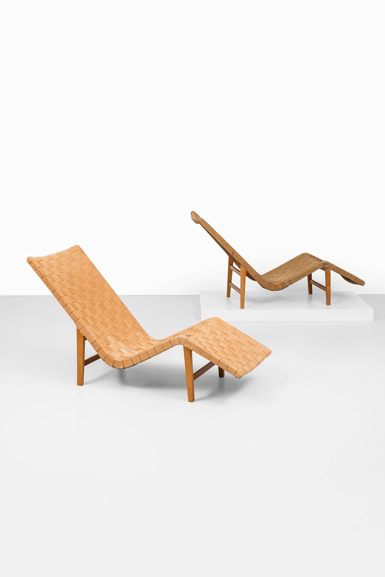 Rare pair of Swedish lounge chairs in the manner of GA Berg. Produced in Sweden, 1930s-1940s. Original paper webbing.
