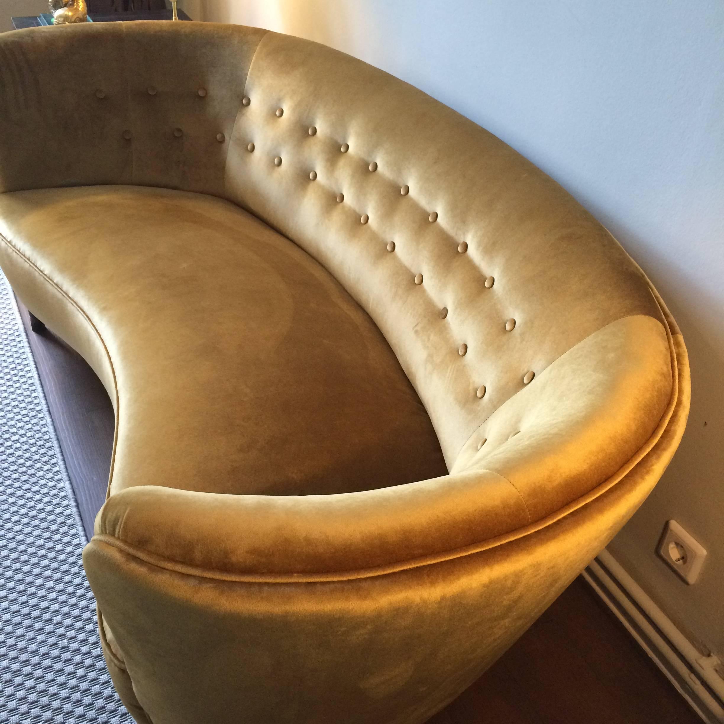Swedish elegant curved mid-century sofa. New upholstered with golden velvet.
Front legs with brass ends.