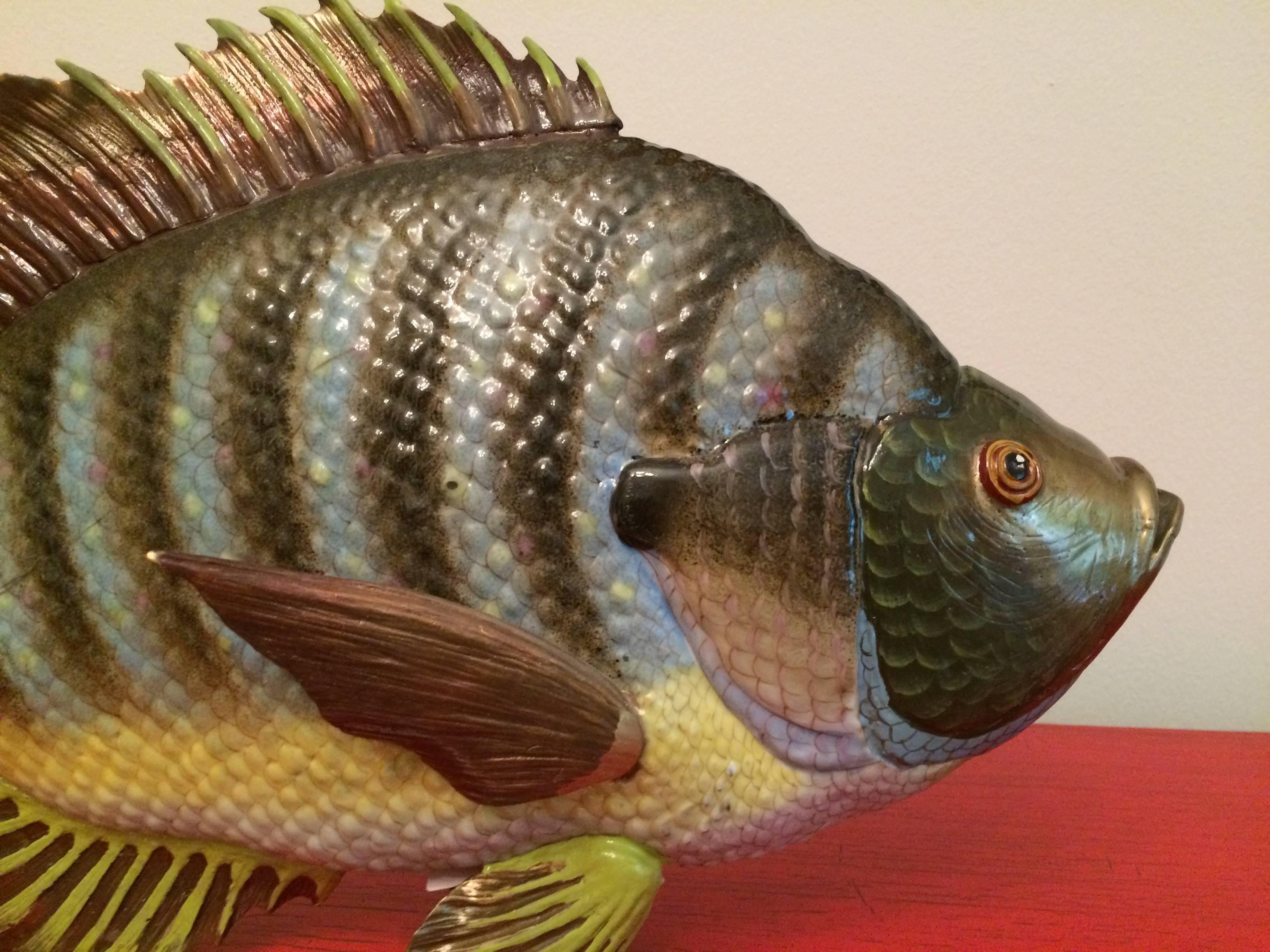 Huge detailed sculpture of a bass.
Brass model natural colored.