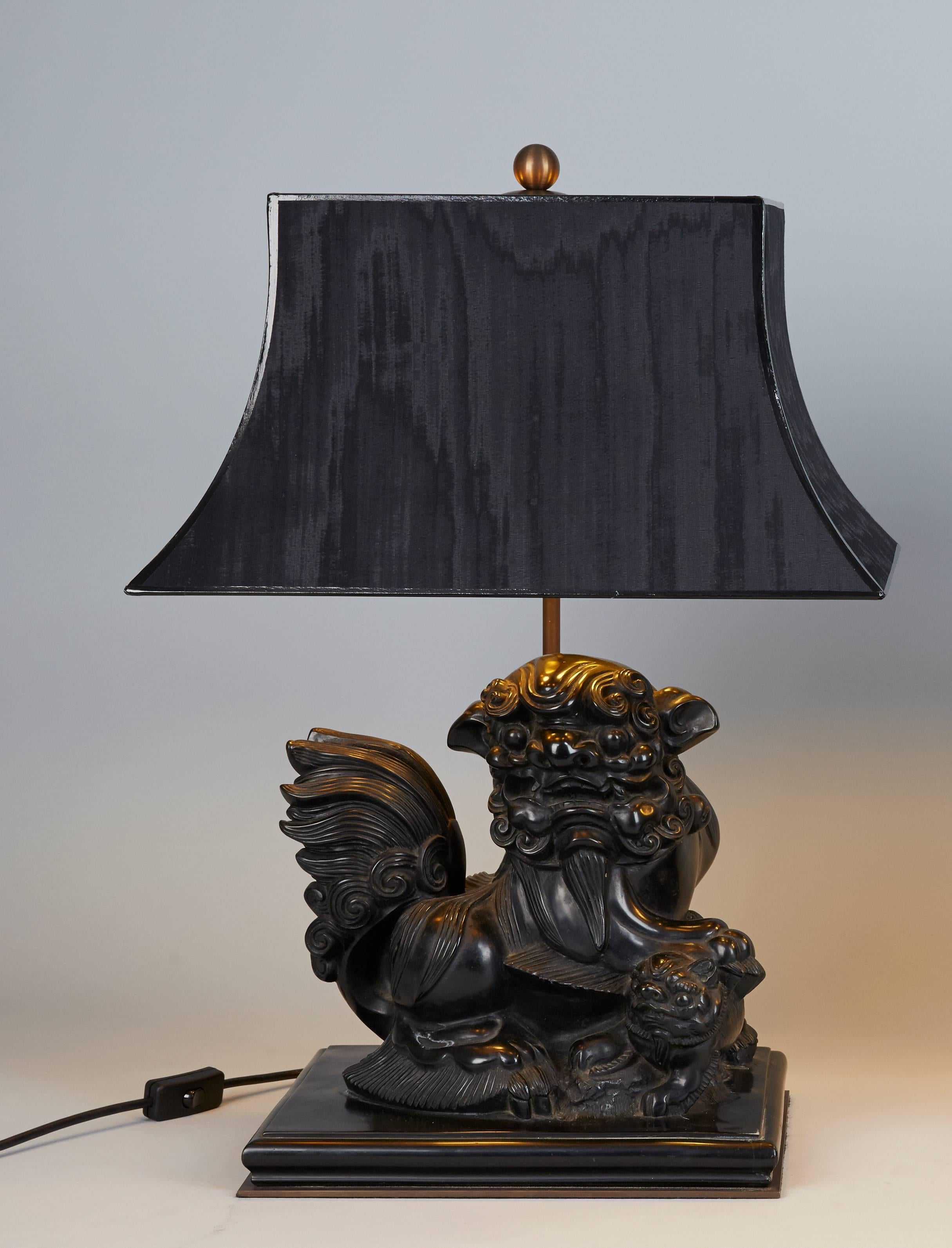 Pair of cast stone foo dog lamps. Very nice carving, new wiring. Silk covered pagoda shade. Lamps are very heavy.
     
