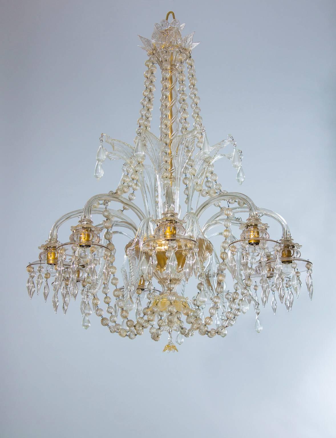 Murano Glass Chandelier with Hanging clear Glass Sphere and Strings Italy 1950s.
Entirely handcrafted in the 1950s in Murano, the Venetian island famous for its unrivaled blown glass tradition, this chandelier is made of 9 clear glass arms, each