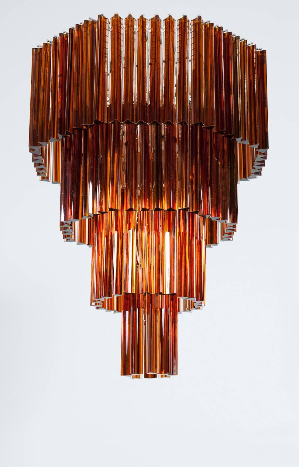 Unique handcrafted Italian Murano Venetian Murano Glass Chandelier in excellent original condition, attributed to Venini circa 1970, in a beautiful octagonal shape with four levels of heights, composed by glass Triedro elements in dark amber, with