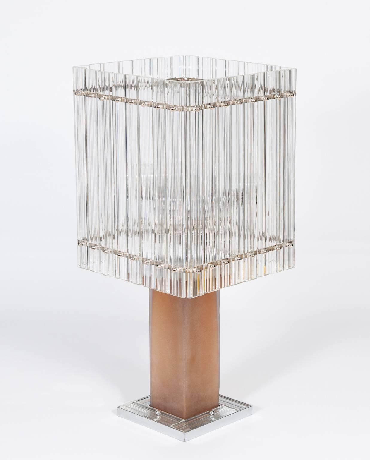 Pair of Italian table lamps in Transparent Murano glass, circa 1980s.
These amazing table lamps were made circa 1980s in the Venetian island of Murano, Italy. Each lamp is composed of a metal base, four transparent glass ribbed slats, an