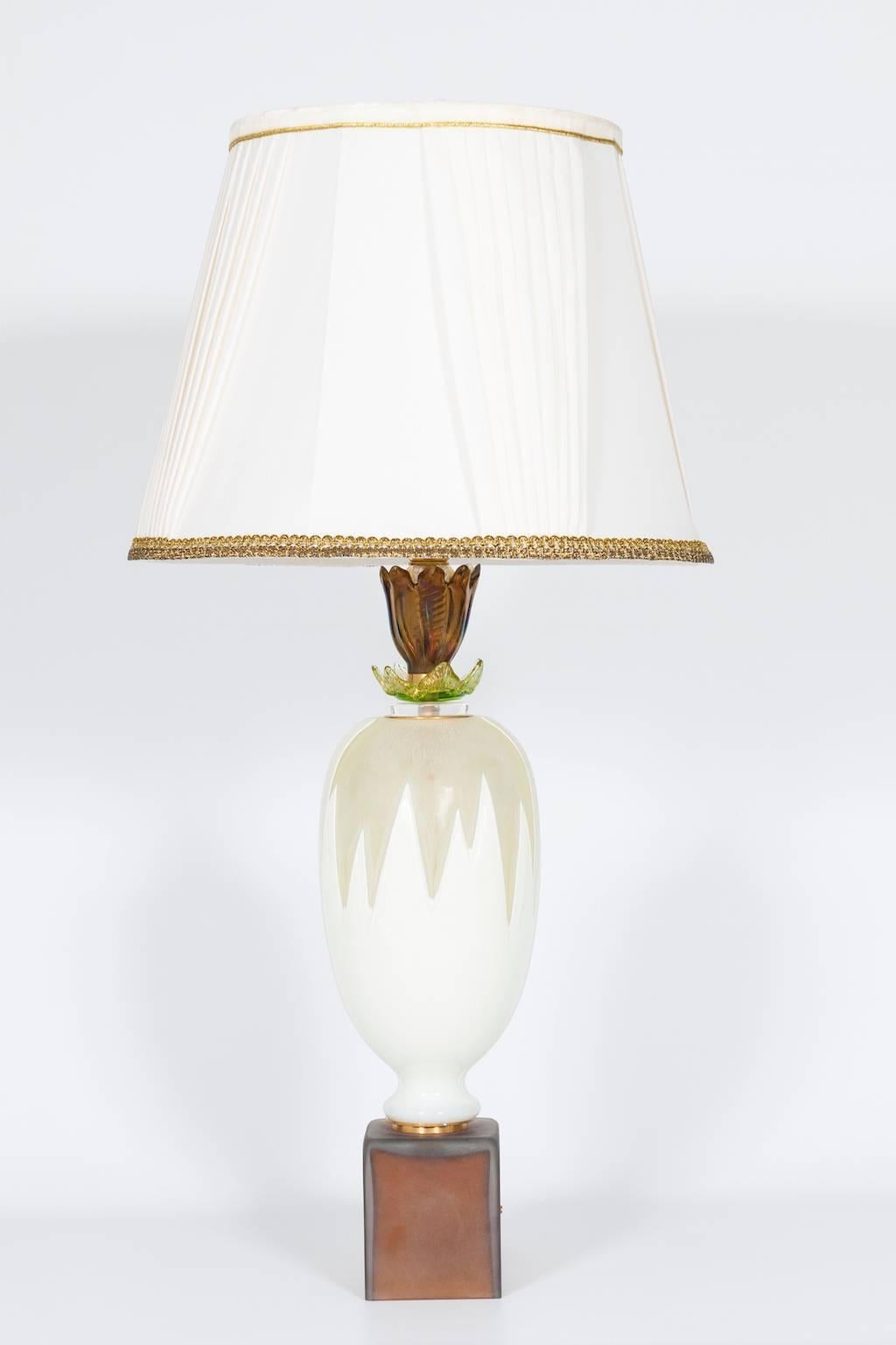 Unique Italian Murano glass table lamp in colors amber, white and green, in excellent condition, contemporary art, circa 2010s. The table lamp is 24.41 inches high, by 7.09 inches diameter and having one light.

We can professionally rewire this