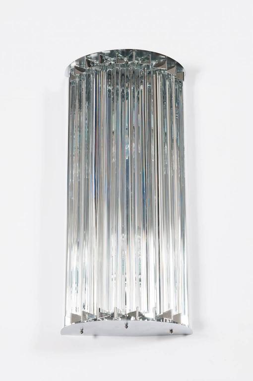 Italian Venetian Murano glass wall sconce, in very excellent original condition attributed to Venini, circa 1960s, composed by transparent glass triedro elements, with an original chrome frame. The sconces are 23.62 inches high, 5.91 inches deep by