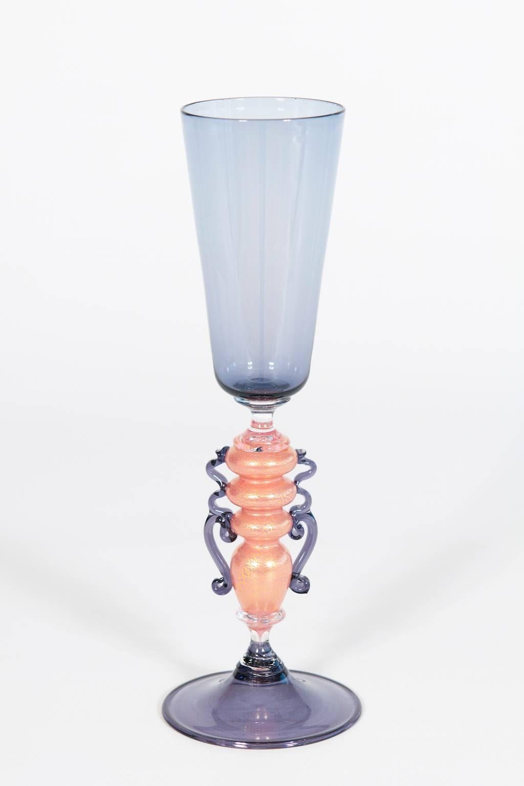 Handcrafted Murano glass Goblet 1970s light purple with accents of pink and gold.
This exquisite Italian Venetian goblet, meticulously handcrafted in Murano glass during the 1970s, features an elegant design, combining light purple with accents of