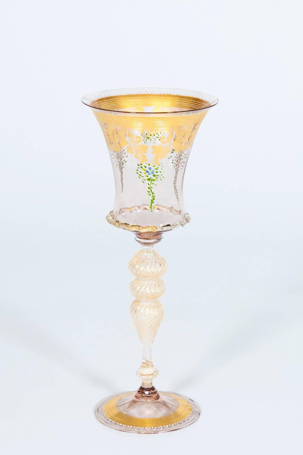 Handcrafted gold glass goblet from 1970s Murano decored with exquisite gold leaf.
In an exceptional state of original preservation, the goblet boasts a light-pink base and a stem adorned in gleaming gold, gracefully supporting a delicate light-pink