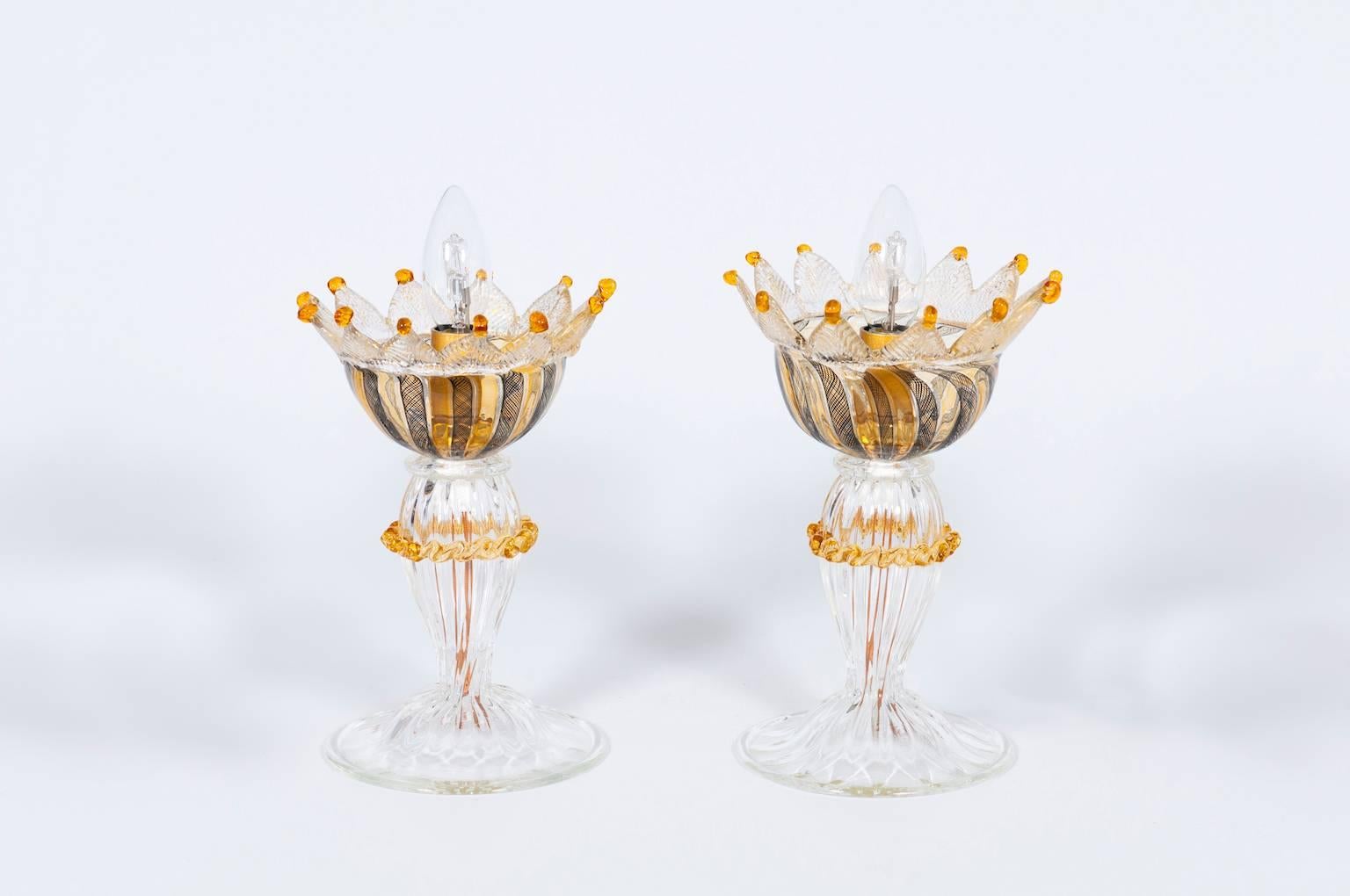 Fantastic mid Modern, Italian Venetian, Pair Table Lamps, Blown Murano Glass, Amber, Filigrana, 1970s, composed by a transparent glass base with amber curd, with at the top a bowl with black and orange treads, called 'Filigrana', submerged in the