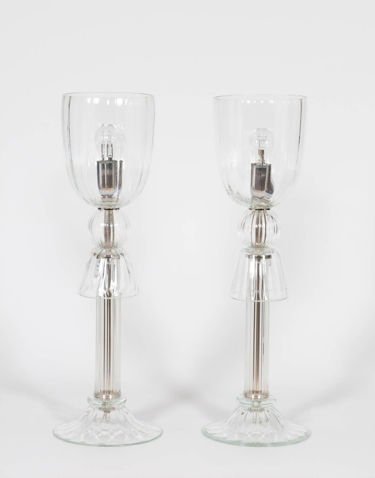 Paar italienische venezianische Tischlampen aus Muranoglas, bestehend aus transparenten Muranoglasteilen, die von einem Chromrahmen getragen werden, in sehr gutem Originalzustand. Seine Herstellung wird auf die 1990er Jahre datiert.
Das Paar