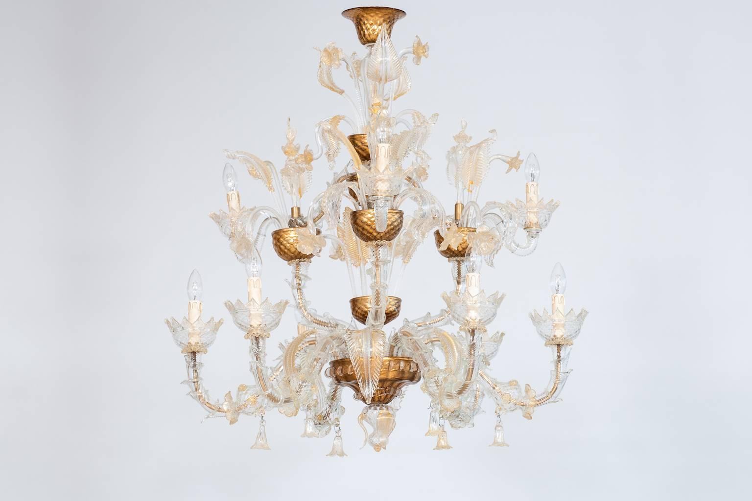 Elegant Italian Ca'rezzonico chandelier in Murano glass transparent and gold, in very excellent original conditions, and without any damages, made circa in 1950s. The chandelier is 37.41 inches high, by 35.43 inches diameter and having nine