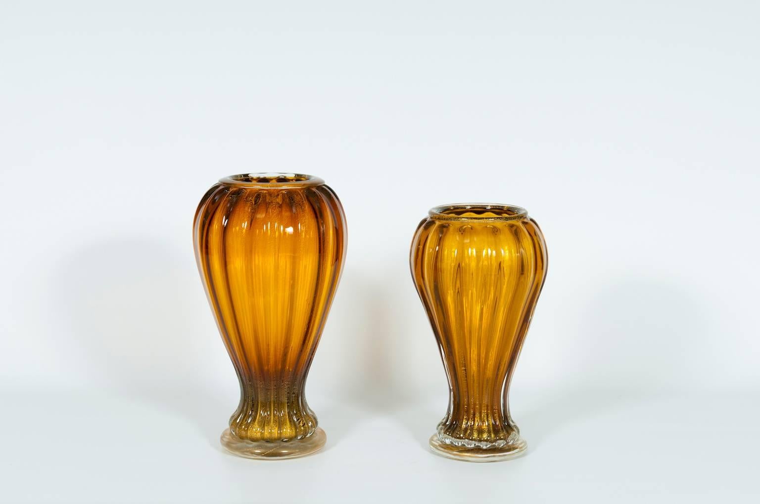 Pair of modern Italian vases in Murano glass amber and gold in two different size, in very excellent original condition, entirely realized handcrafted and handblown in the Venice Murano Island, circa 1990s.
Measures 1° vase:
Height 15.35 in. / 39