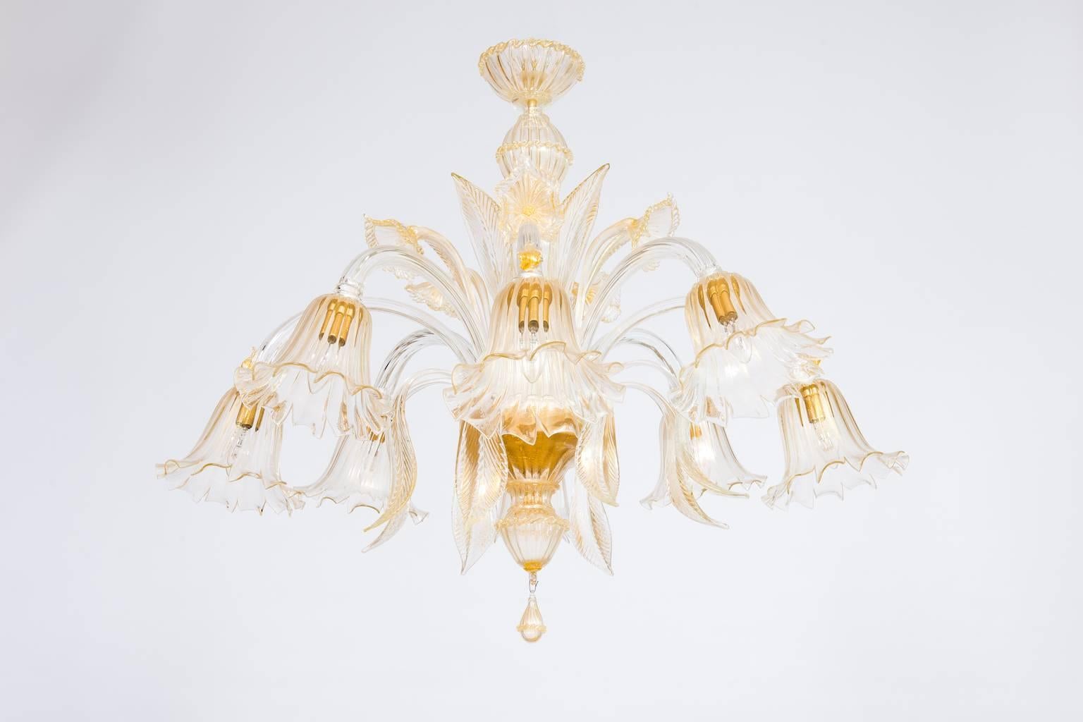 Elegant Italian chandelier in Murano glass transparent and 24-karat gold, composed of very detailed parts that represented flower and leaves high and low. All parts were made and realized in the Murano Island, circa 1990s. The chandelier is in very