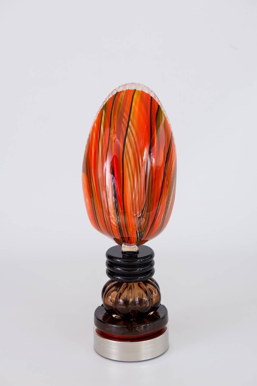 Unique Italian Venetian Blown Murano Glass, handcrafted, Table Lamp, composed by multi colors Murano glass features, and  supported by a chromed frame. The portrait has been manufactured in the Venetian Murano Island, circa 1970s. The table lamp is