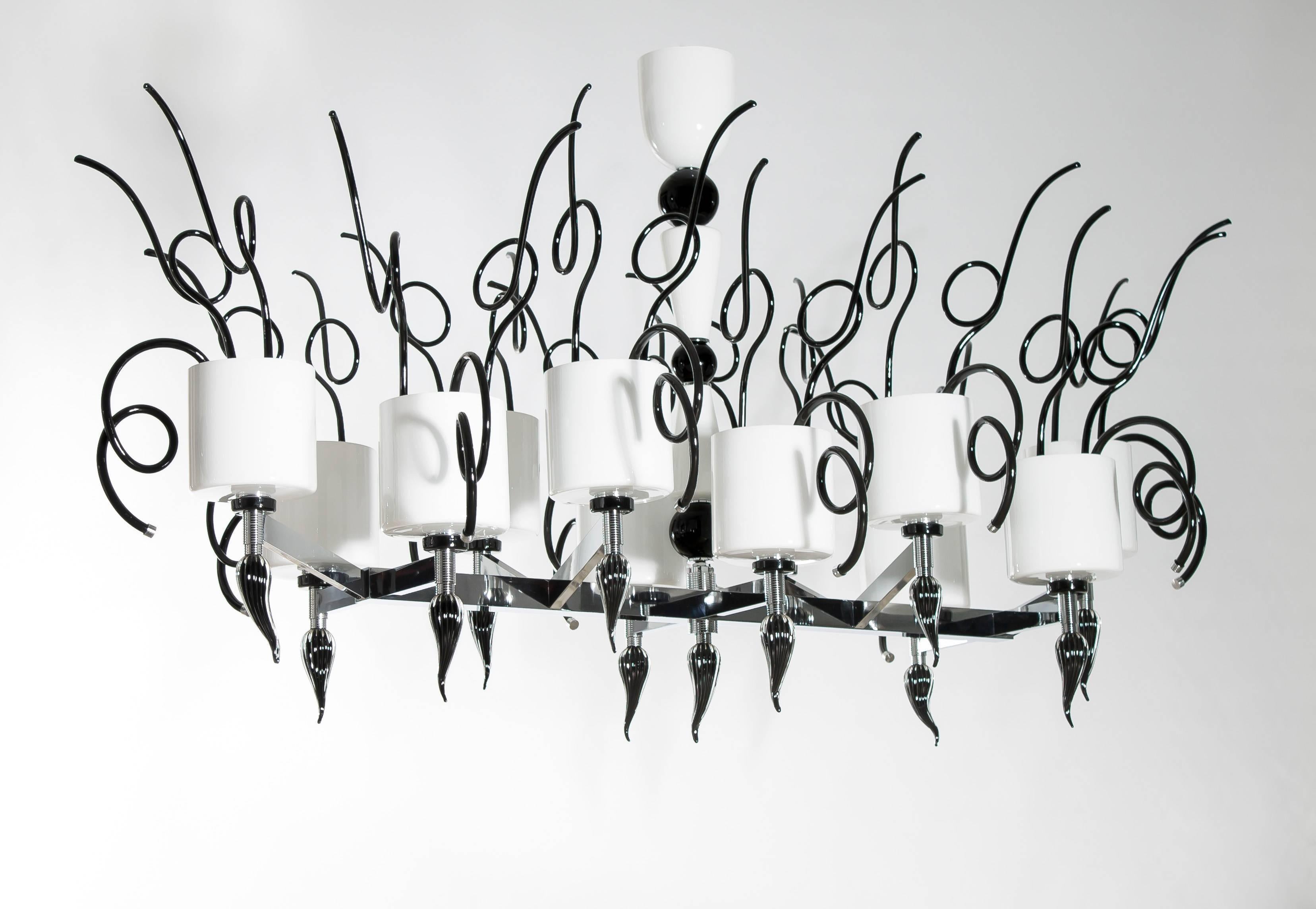 Curly Chandelier black and white in blown Murano Glass contemporary Italy
The chandelier is composed by a fantastic chromed framework, where twelve arms  are disposed in different heights generating a gorgeous artwork. Each arm supports a