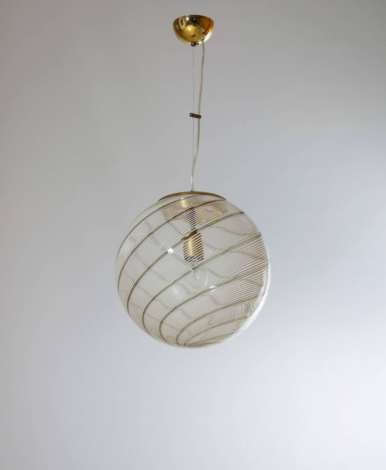 Vintage Murano Fixture: Clear Glass Sphere with Accented Stripes 1960s Italy.
A Timeless Murano Glass Sphere Fixture with Delicate Stripes: A Legacy of Venetian Artisanship. This exquisite Murano glass sphere fixture, crafted in the 1960s and