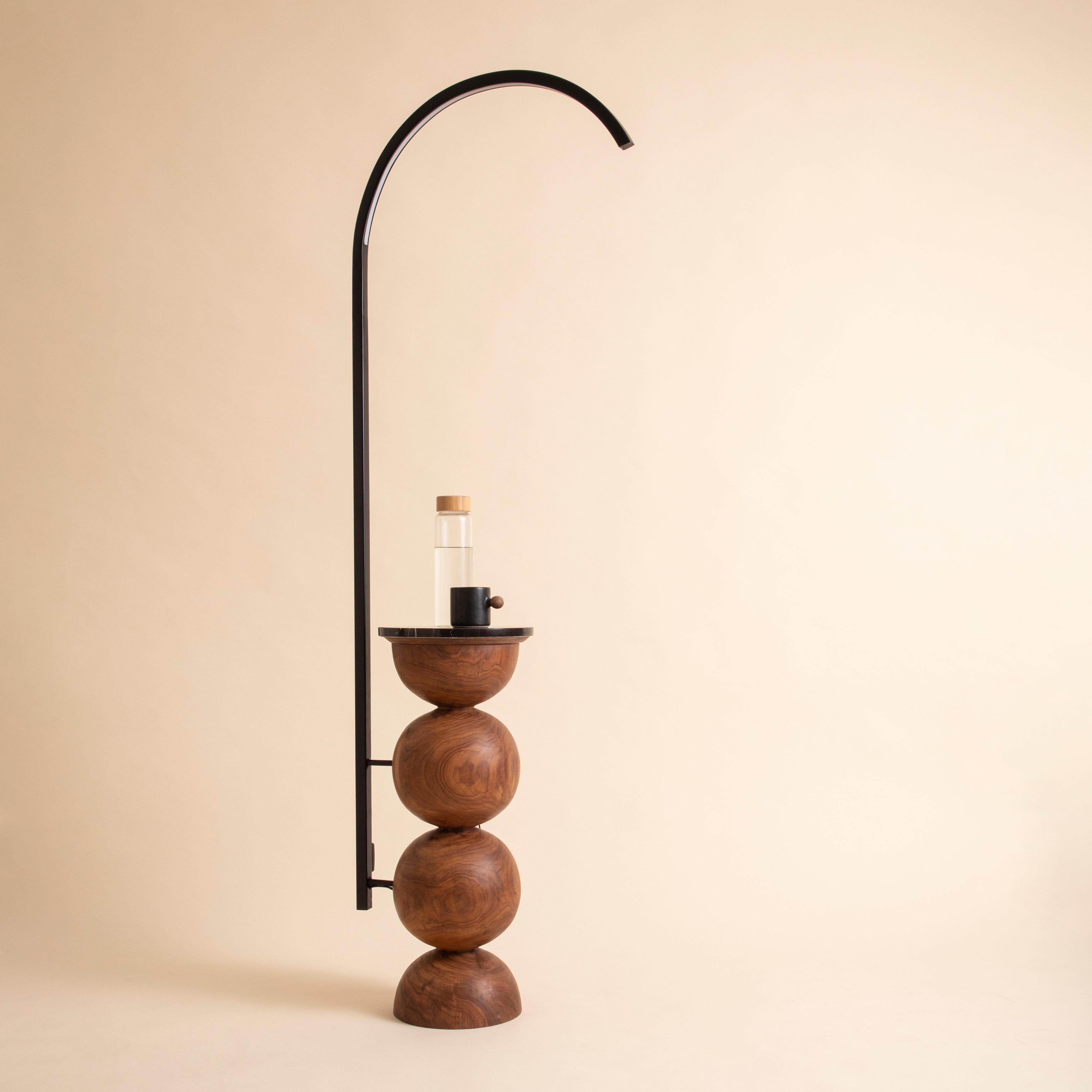 Sculptural yet minimal, our floor lamp is crafted from a single piece of wood and designed to softly illuminate your space with quiet drama.  A slender crevice runs through the body, casting a subtle sliver of light that creates a warm, ambient