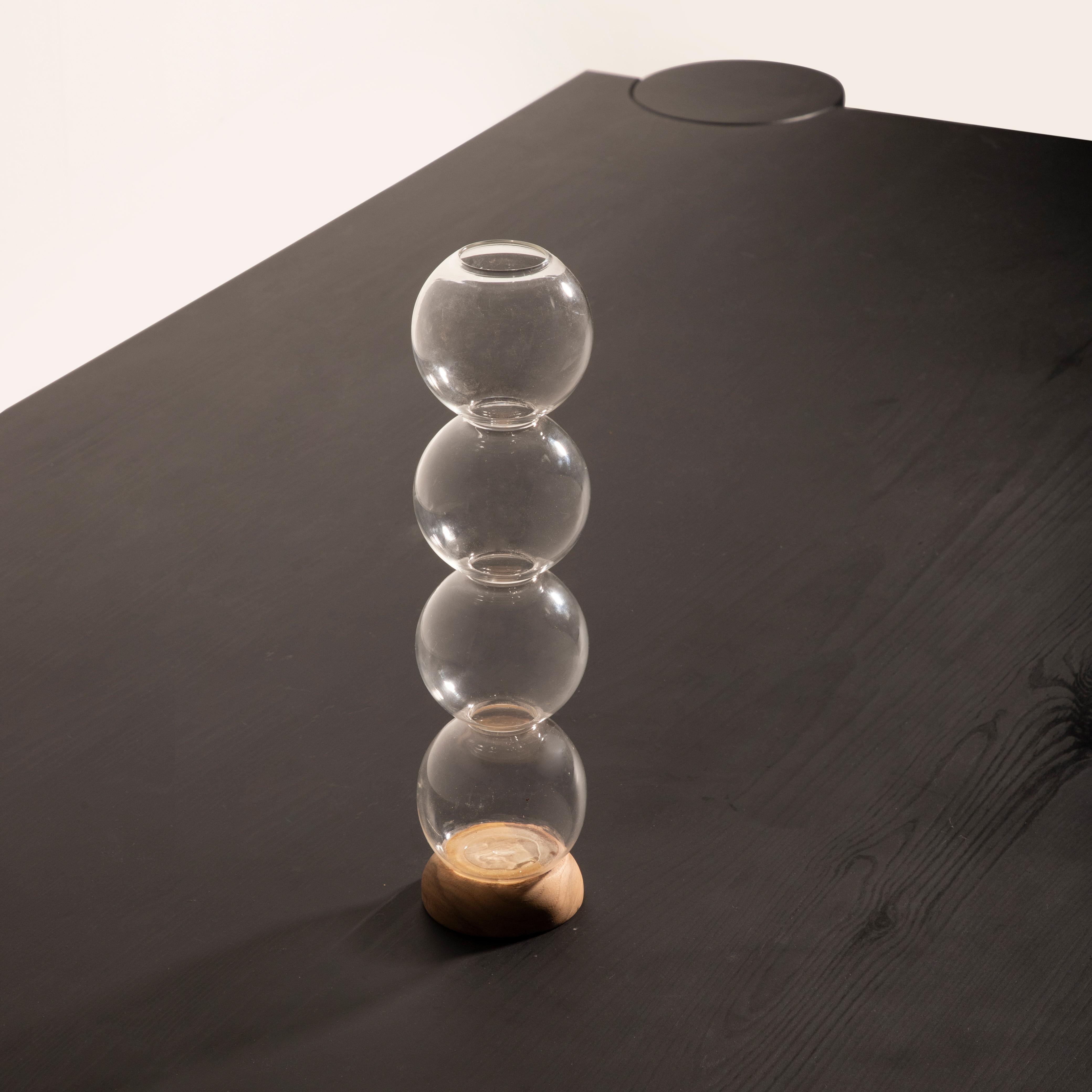 Part of our signature Ball Collection, the Ball Pack Vase set is a celebration of modern design, timeless form, and artisanal craftsmanship. Hand-blown from glass, each vase showcases a sleek transparency that adds lightness and sophistication to
