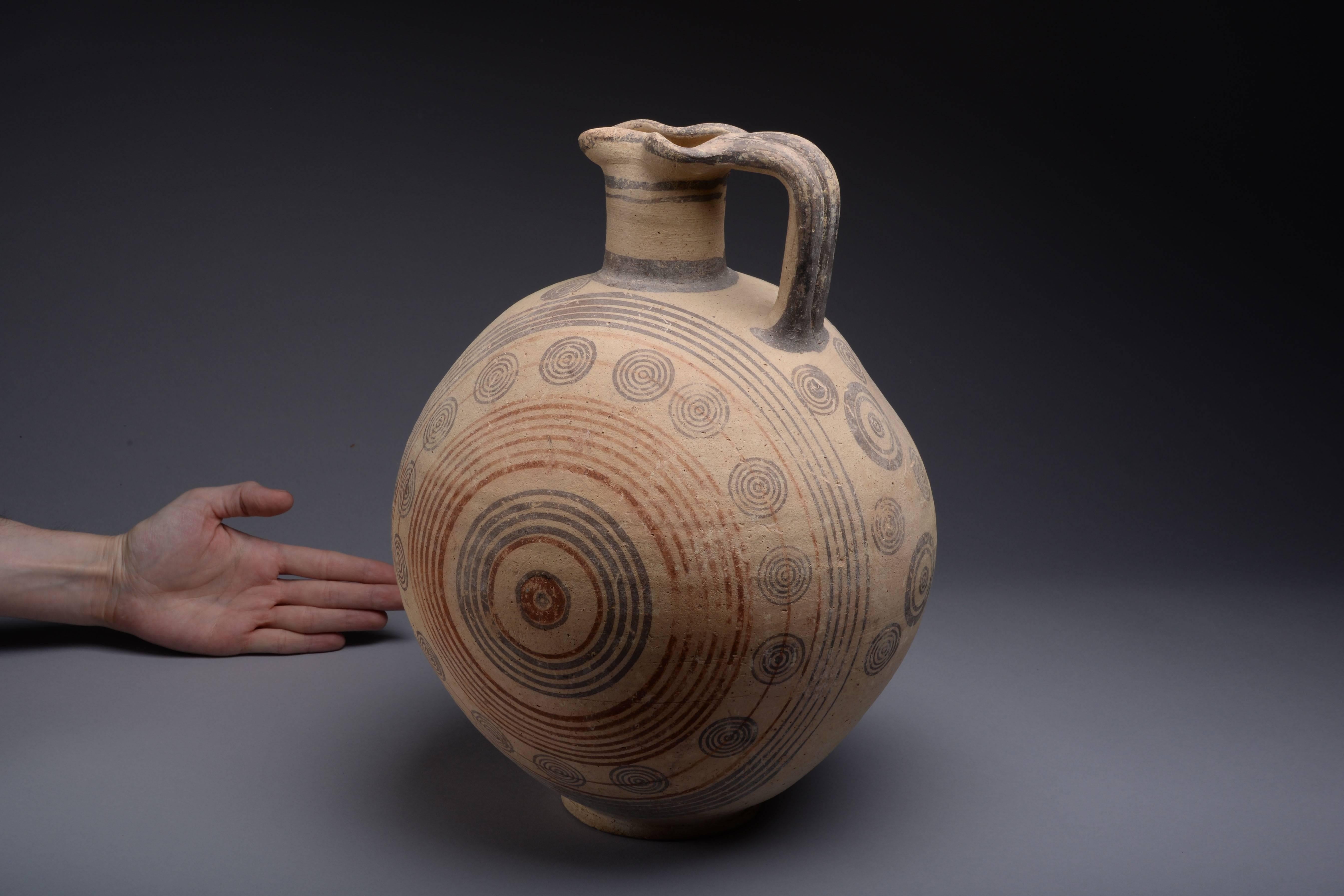 An exceptional, large bichrome jug (or oenochoe), from the Cypro-Geometric period of Cyprus, dating to approximately 950-750 BC. 
 
A fantastic example of an iconic Cypriot type, seldom found of this size, condition and with such a strong