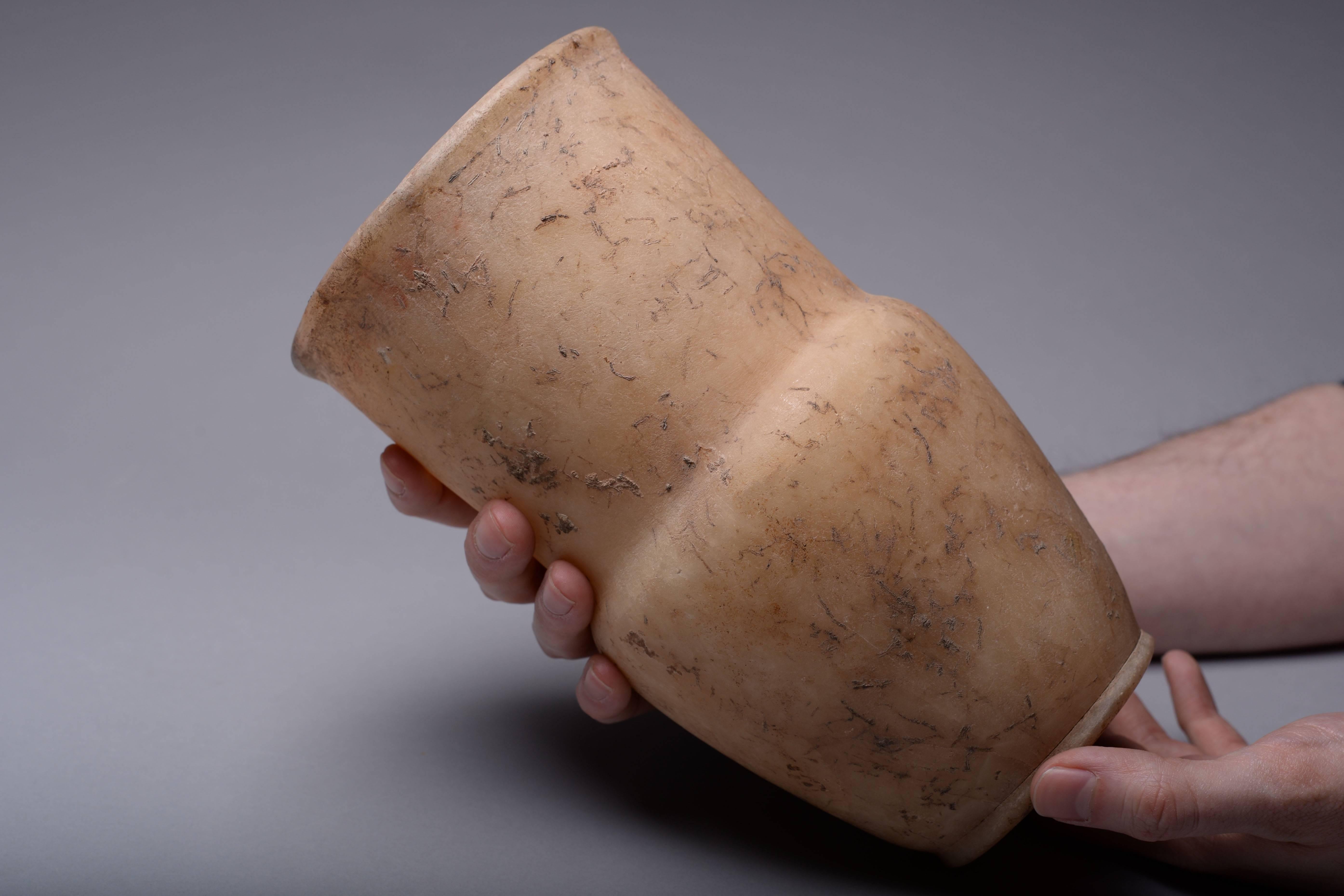 A beautiful, large ancient Egyptian alabaster vase, dating to the New Kingdom, circa 1550-1070 BC.

A large and impressive vase, with a ribbed circular base, short body, bulging slightly at the shoulders and a tall fat neck with rounded rim.
