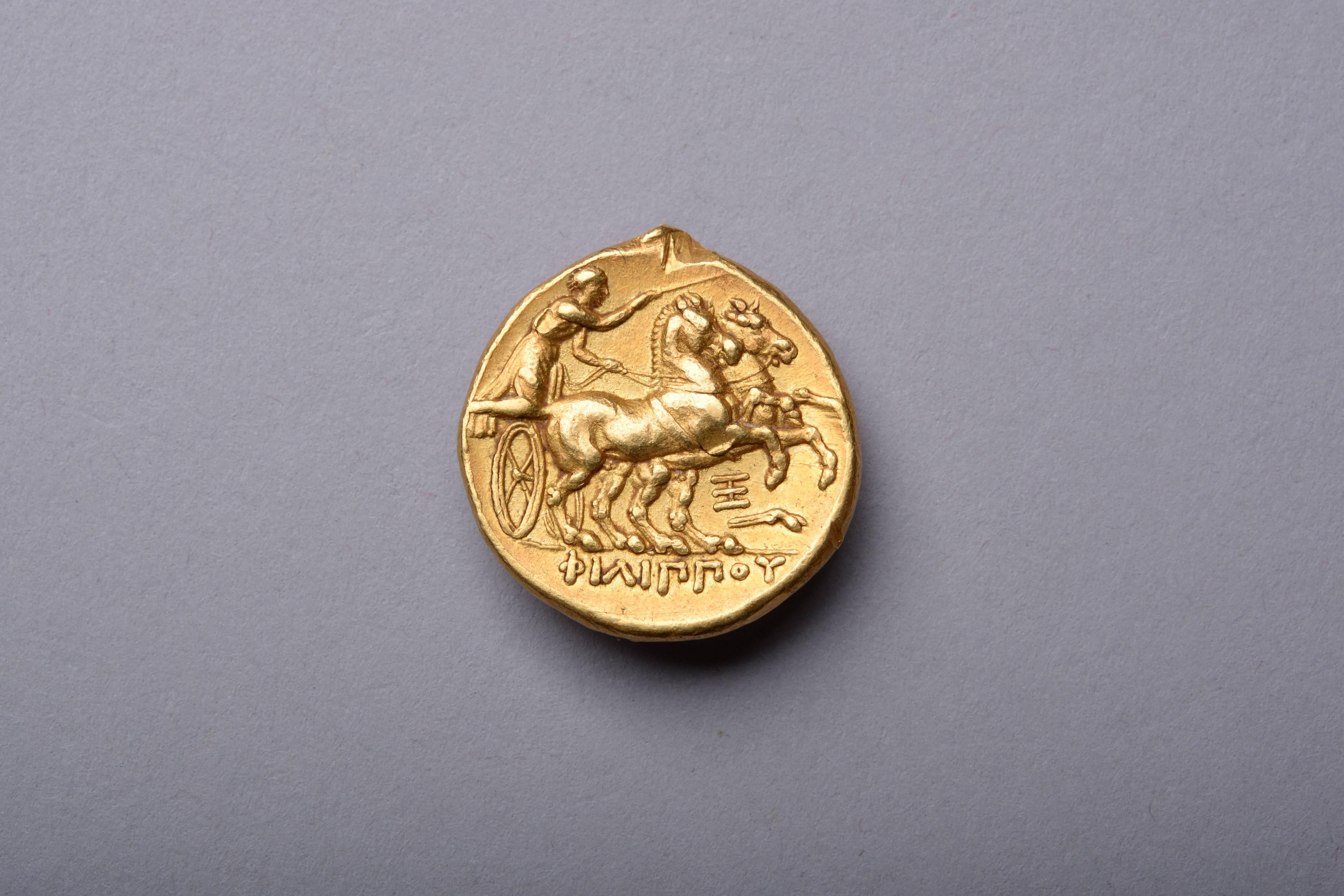 A beautifully toned ancient Greek gold stater, minted in the name of the brilliant King Philip II of Macedon. Issued, circa 323-316 BC, at the Abydos mint.

The obverse with a youthful portrait of the god Apollo, shown with unruly hair, slightly