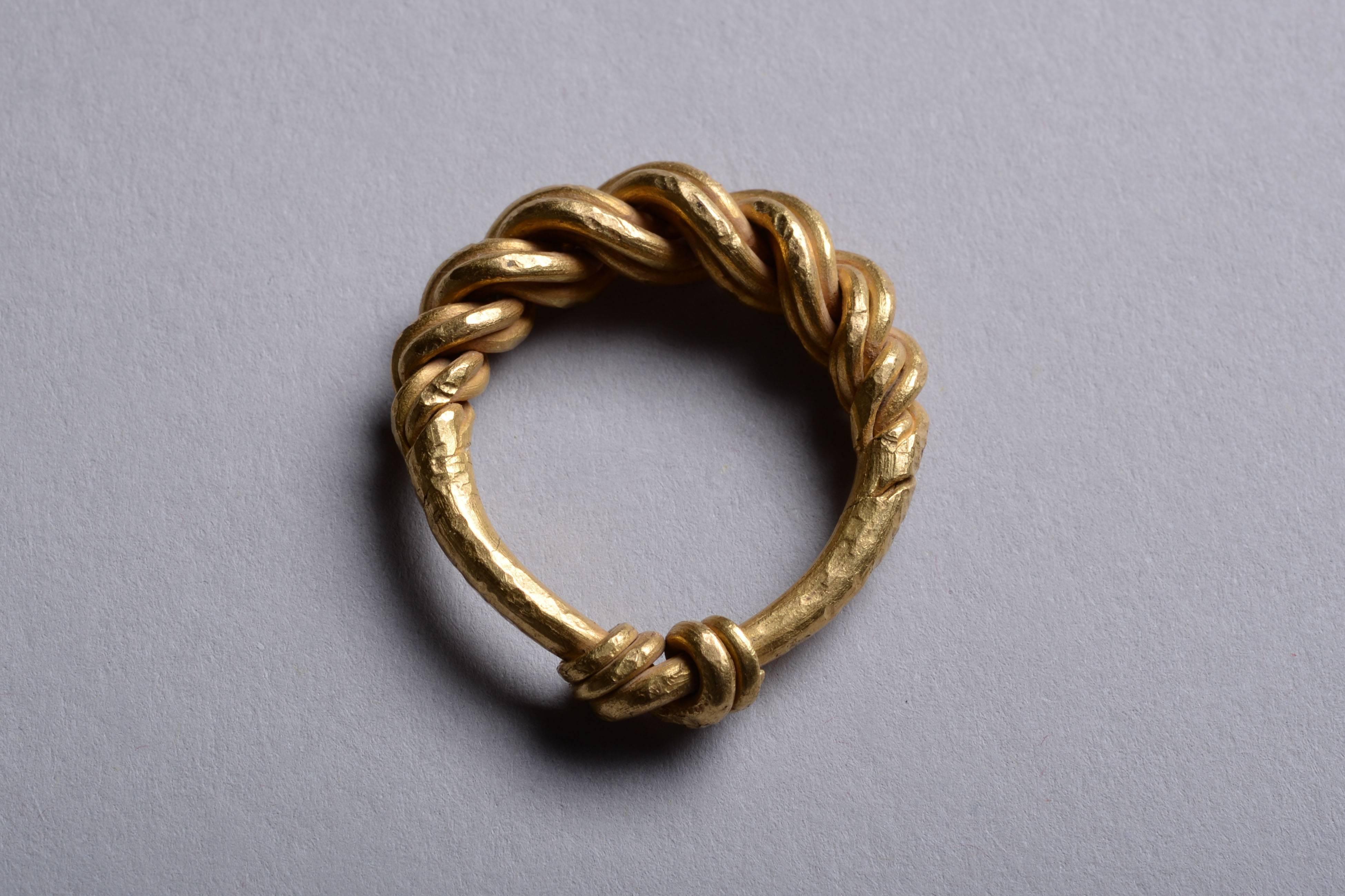A beautiful braided Viking ring, dating to approximately 950 AD.

An intricately formed piece; the upper part formed of four gold wires, tapering slightly towards the shoulders and becoming a single strand, then on the underside the four strands