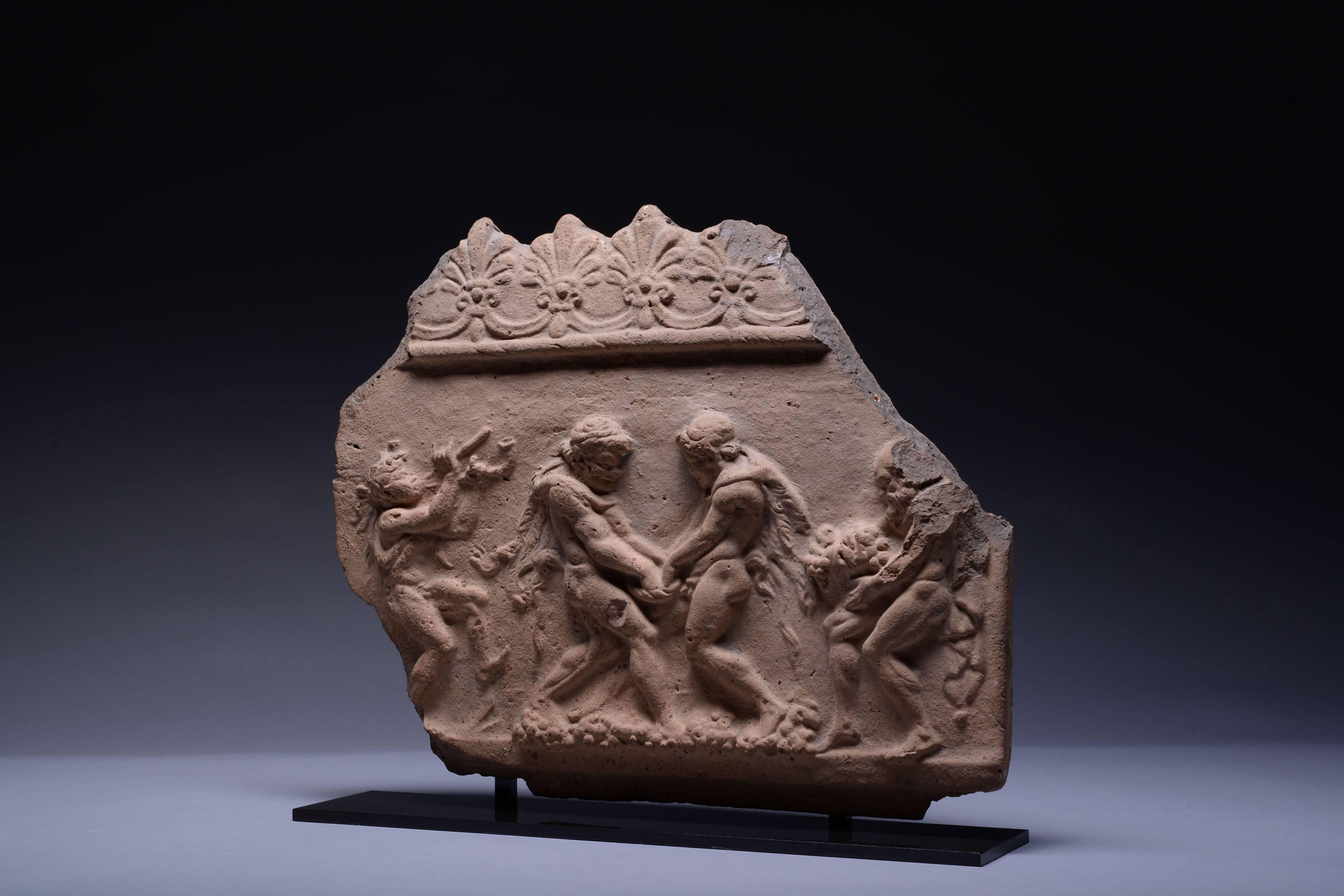 An ancient Roman pottery Campana relief, dating to early the 1st century BC.

Showing a Greek Dionysiac scene, of satyrs making wine. In the centre of the scene, two satyrs, dressed only in panther skins, plunge their hands deep into a basket,