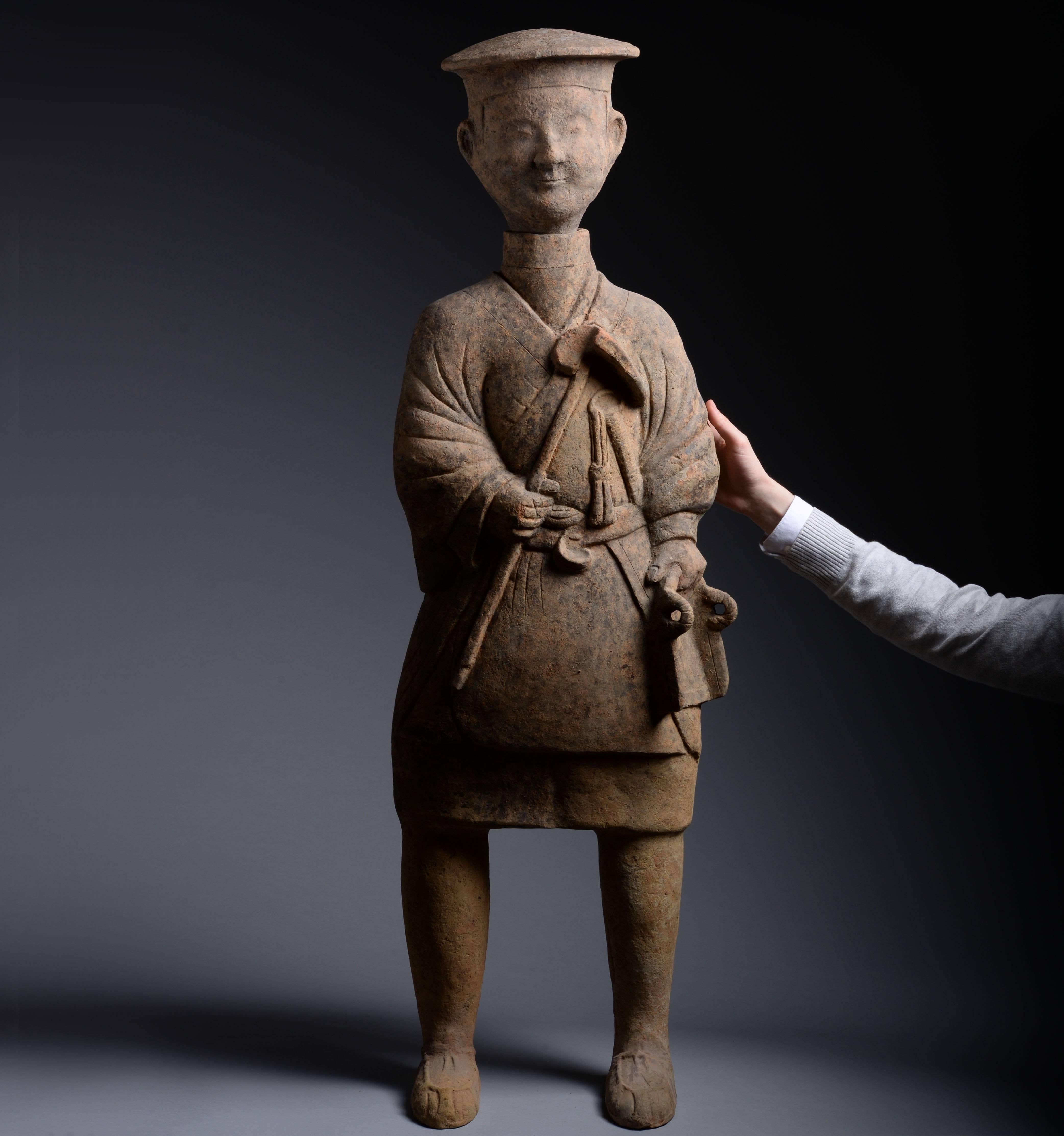 An ancient Chinese Eastern Han dynasty terracotta figure of a farmer, likely from Sichuan province and dating to 25–220 AD.

Standing at almost four feet tall, this decorative sculpture towers over most terracotta figures produced during the Han