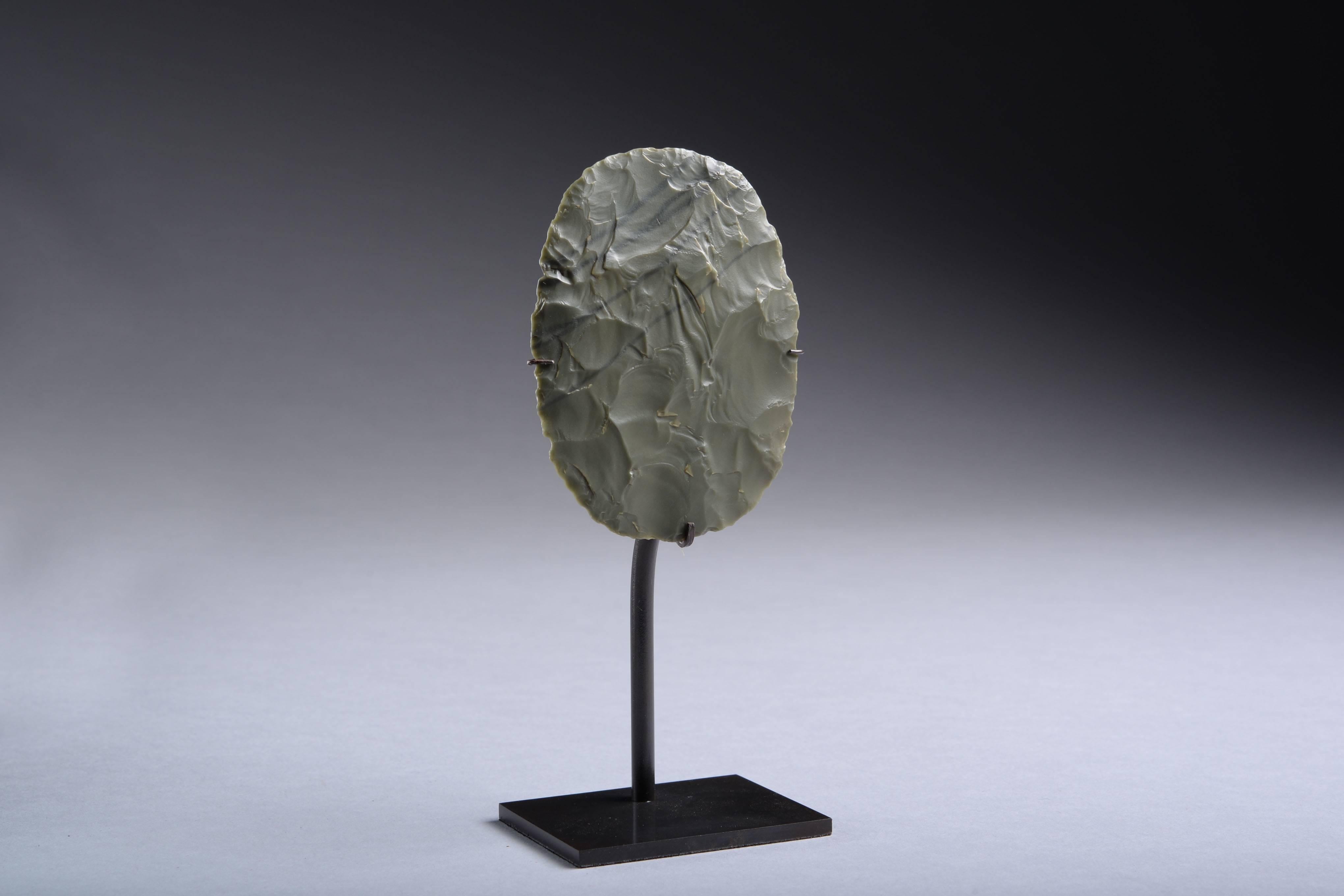 A beautiful Neolithic green jasper sun disc scraper from the Tenerian Culture of West Africa, dating to around 7000 years before present. 

Worked with incredible precision, pressure flaked from a dark green piece of veined jasper. 

It must