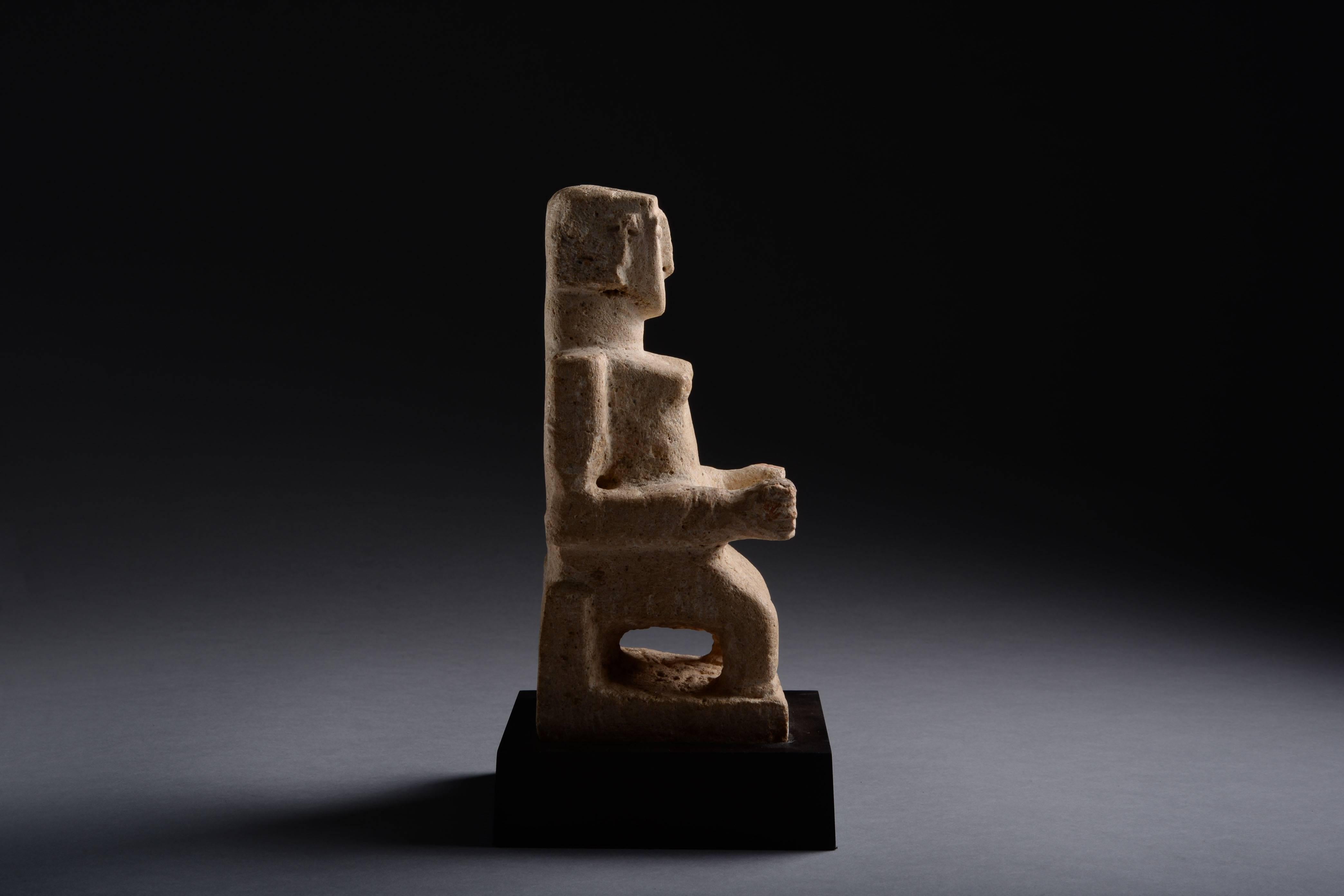 This enigmatic piece depicts a seated female with striking abstract features. Though its original function is now unknown, it likely has its roots in the religious traditions of pre-Islamic Arabia, and might have been a votive offering from an