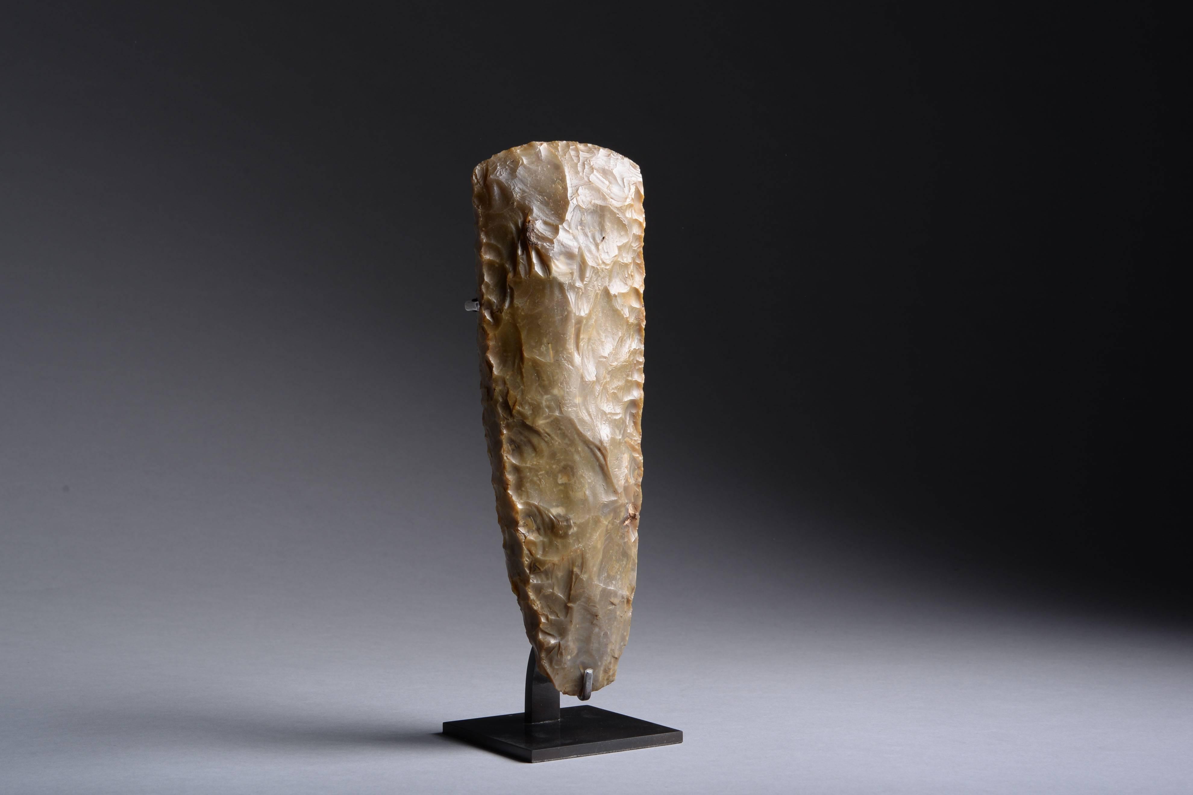 A large Neolithic thin-butted flint axe from Denmark, dating to approximately 4000-3000 BC.

Finely knapped from a large piece of greenish-grey flint, the sides with beautiful 'stitching' marks. 

This tactile stone tool dates to the north-west
