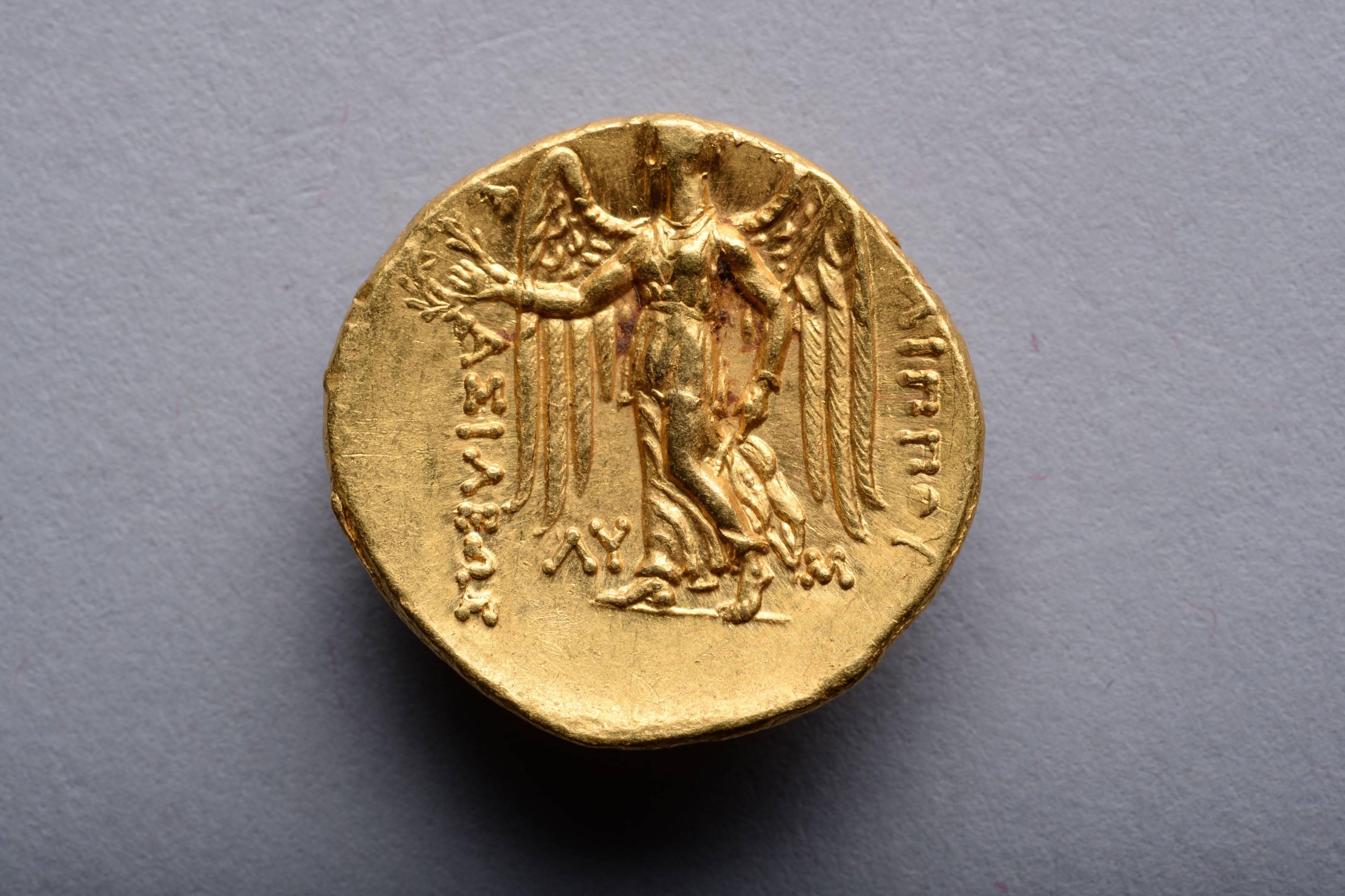 An Alexander the Great gold stater issued under King Philip III Arrhidaeus. Struck at the Babylon mint, 323 - 317 BC.

The obverse with a beautiful portrait of Athena, goddess of wisdom and warfare. The deity is shown wearing a beaded necklace, her