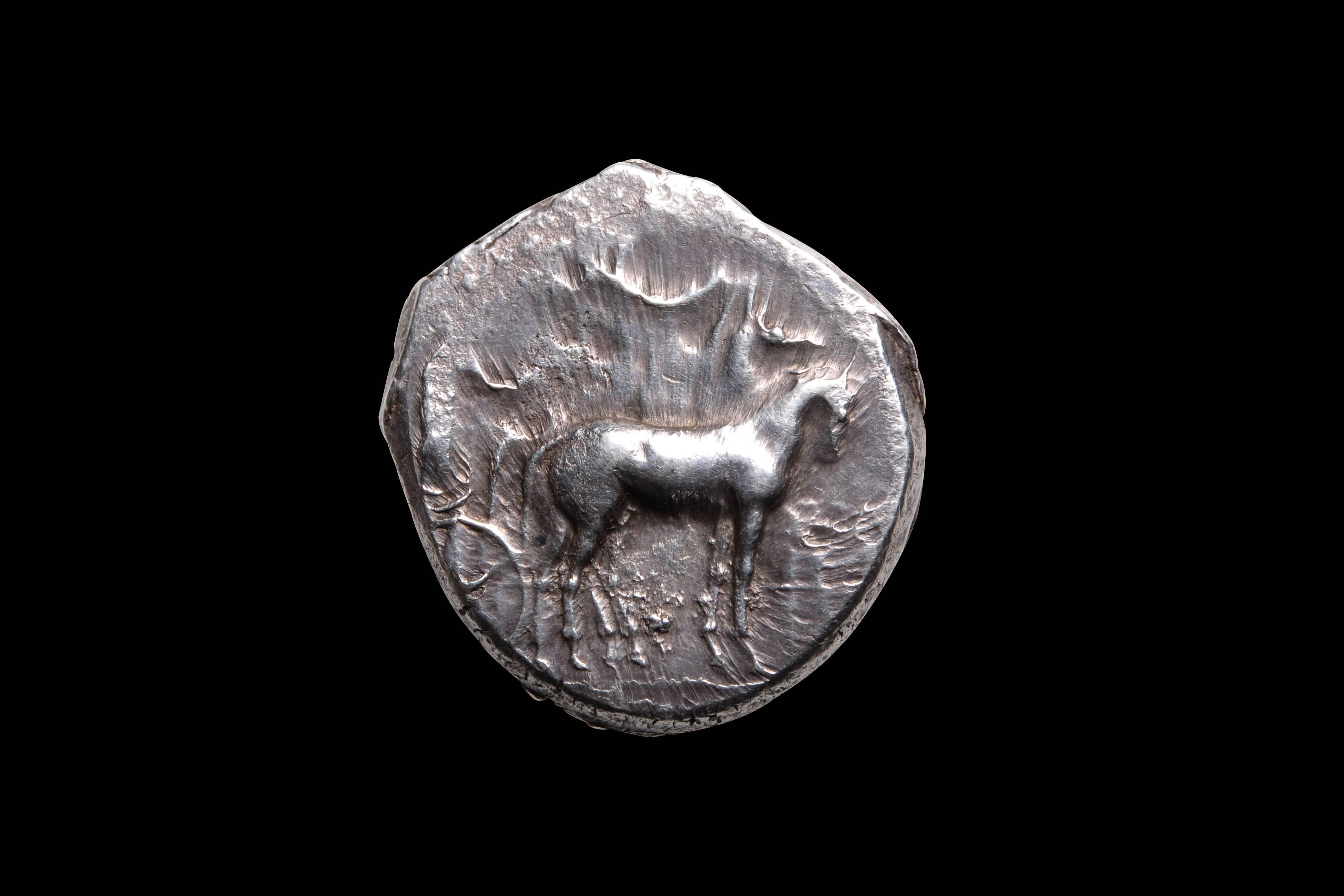 A beautiful, refined work of Classical Greek art. A toned and well centred ancient Greek silver tetradrachm, minted by the city of Gela, on the island of Sicily, circa 420 - 415 BC.

The obverse (image ii) with charioteer, driving slow four horse