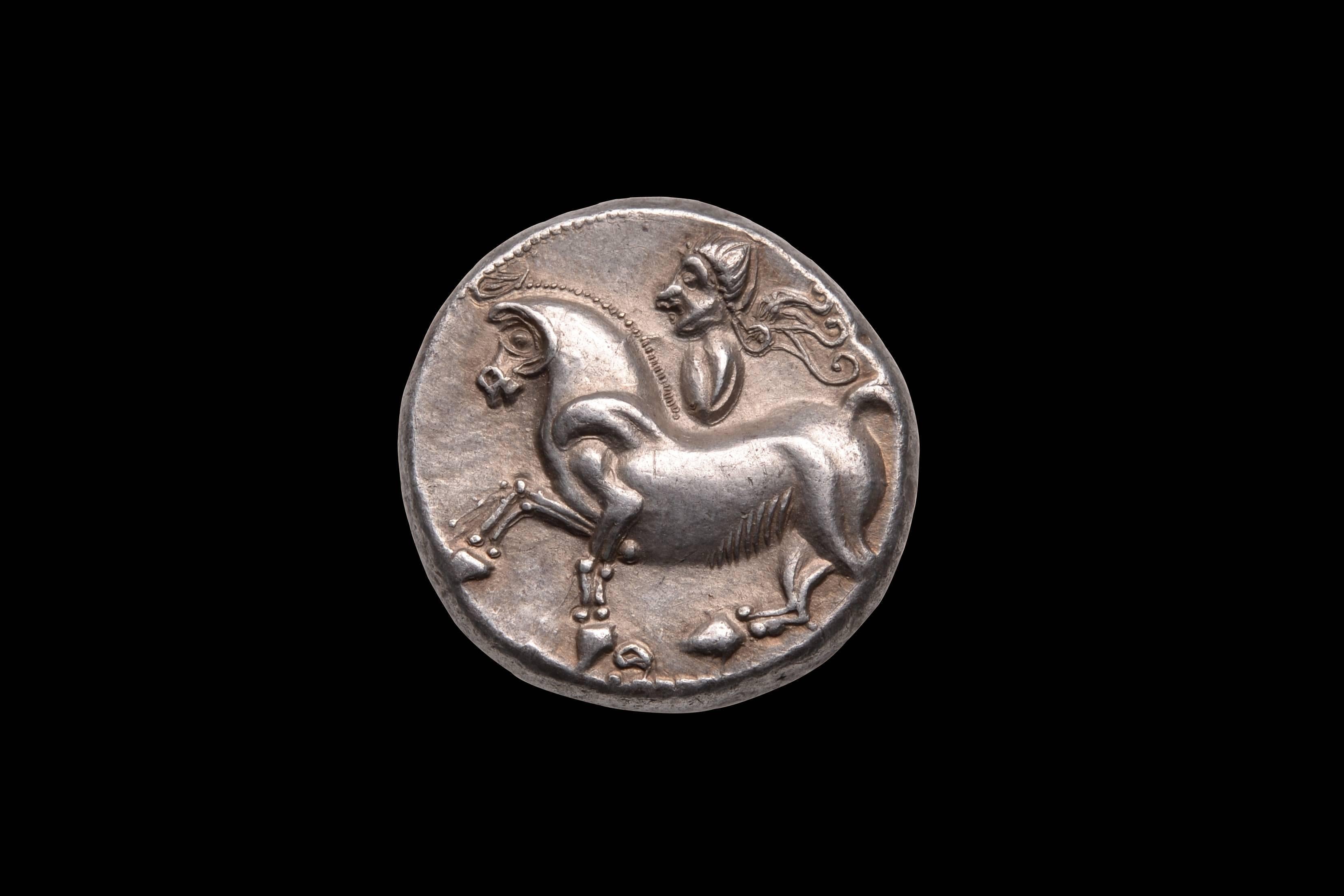 An exceptional example of abstract Celtic artwork on a coin.

A heavy silver tetradrachm, minted by the Danubian Celts of Pannonia (Burgenland), circa 2nd Century BC.

The obverse with a remarkable portrait of a Celtic warrior, in the very