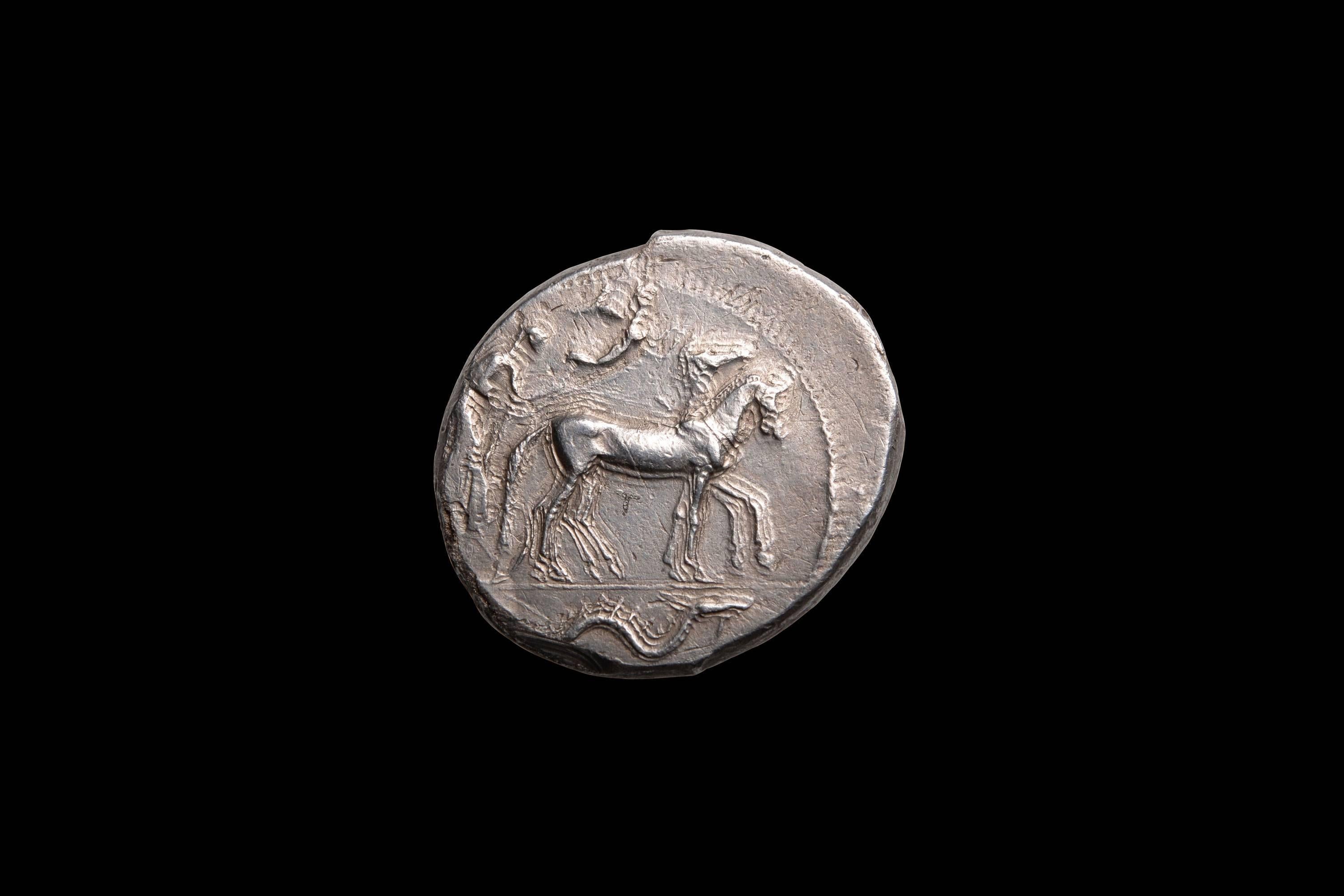 An extraordinarily beautiful and well preserved example of mid 5th Century Syracusan coinage. An ancient silver tetradrachm, from the great city of Syracuse, struck circa 450 BC.  An exceptional example of early Classical, transitional style