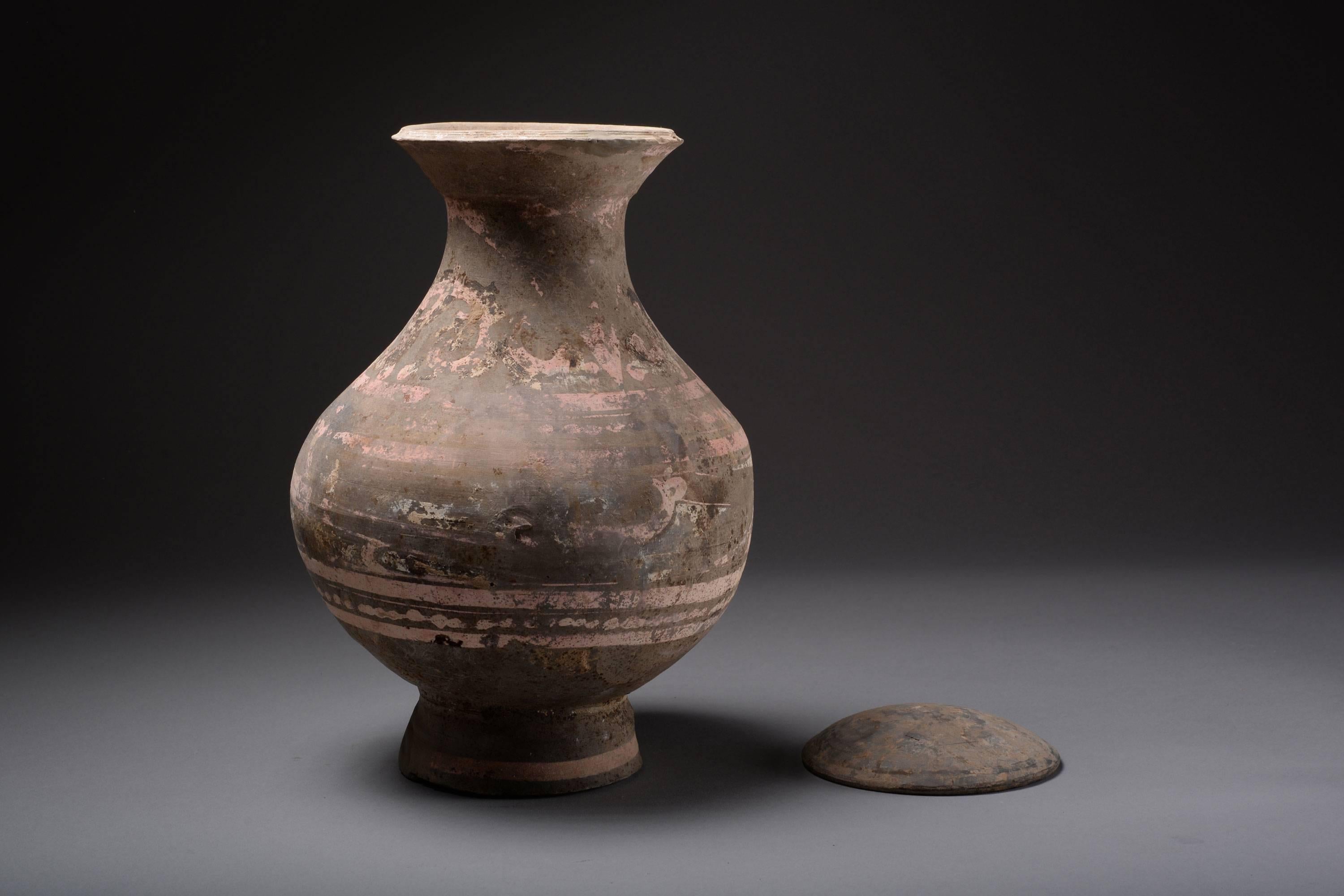 An ancient Chinese Western Han Dynasty pottery Hu, dating to 206 BC – 9 AD.

With the calm elegance that typifies Hu vessels, the bold silhouette and flowing curves communicate both power and grace in equal measure. The piriform body, adorned with