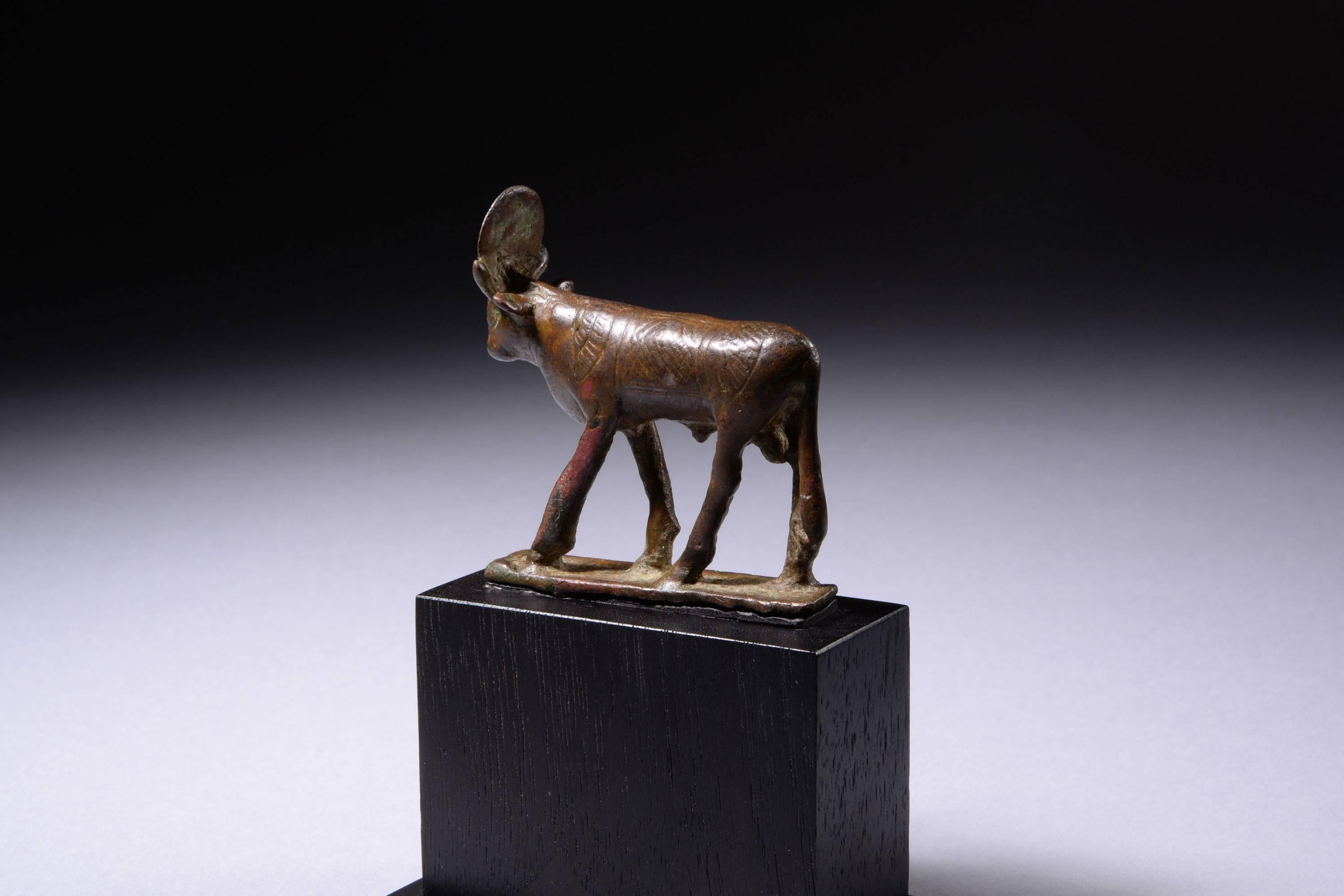 An ancient Egyptian bronze figure depicting Apis, dating to the Late Period, 664 – 332 BC.
 
Striding confidently forward, the beautiful caramel patina of this Apis bull lends a beautiful countenance to the piece. A winged scarab is incised across