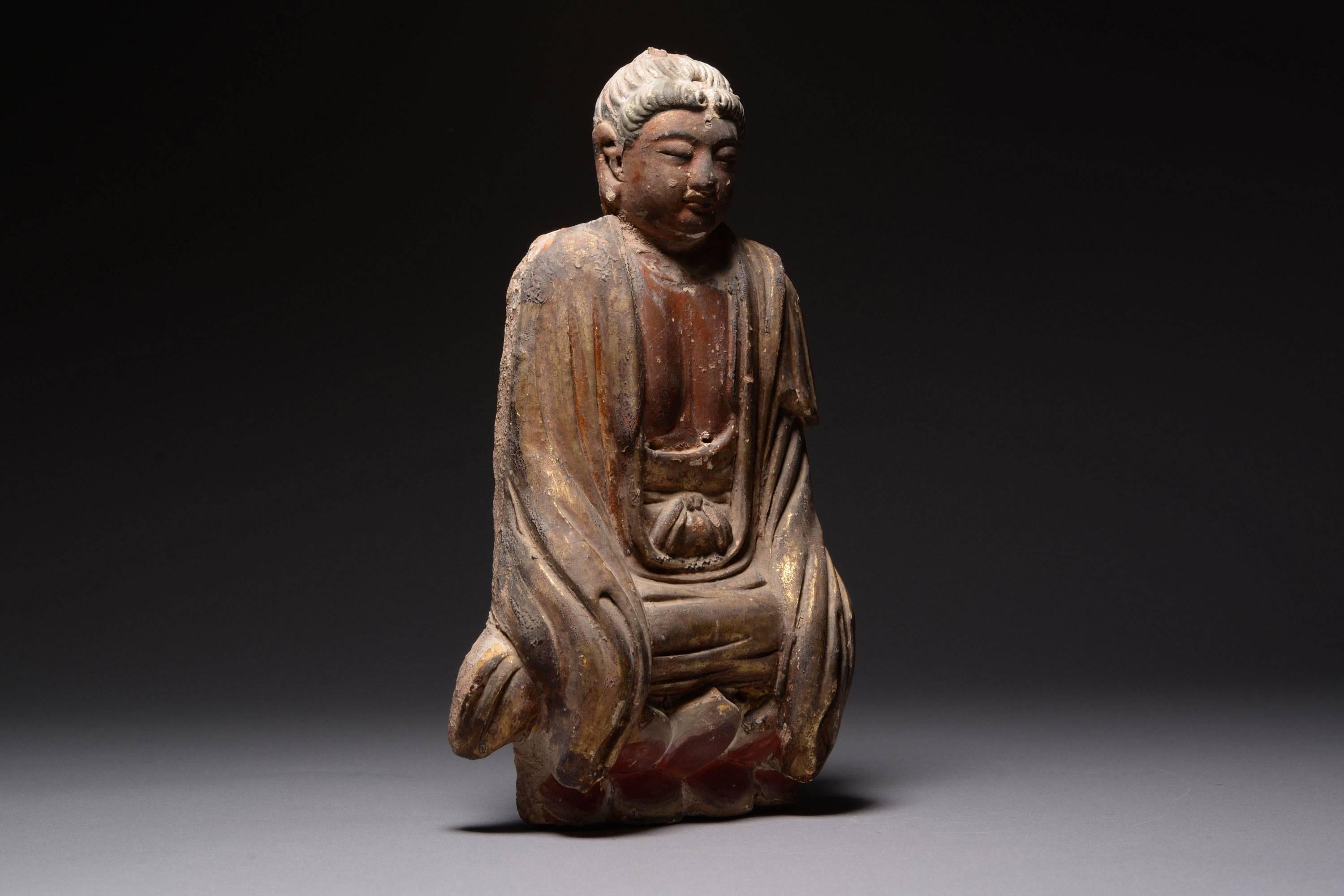 A Chinese Yuan - early Ming dynasty parcel gilt painted terracotta figure of Buddha, dating to approximately 1275 – 1400 AD.
 
This beautiful and elaborate figure of Buddha is a relatively unusual example of medieval Chinese art, being composed of