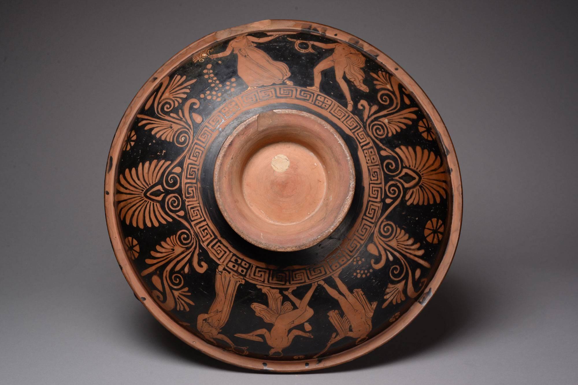 An ancient Greek Apulian red-figure patera, dating to around 320 BC.

A particularly large example of the type, of classic form; the shallow dish set on a ring base, with knobbed handles set bilaterally.

The tondo decorated with a young woman,