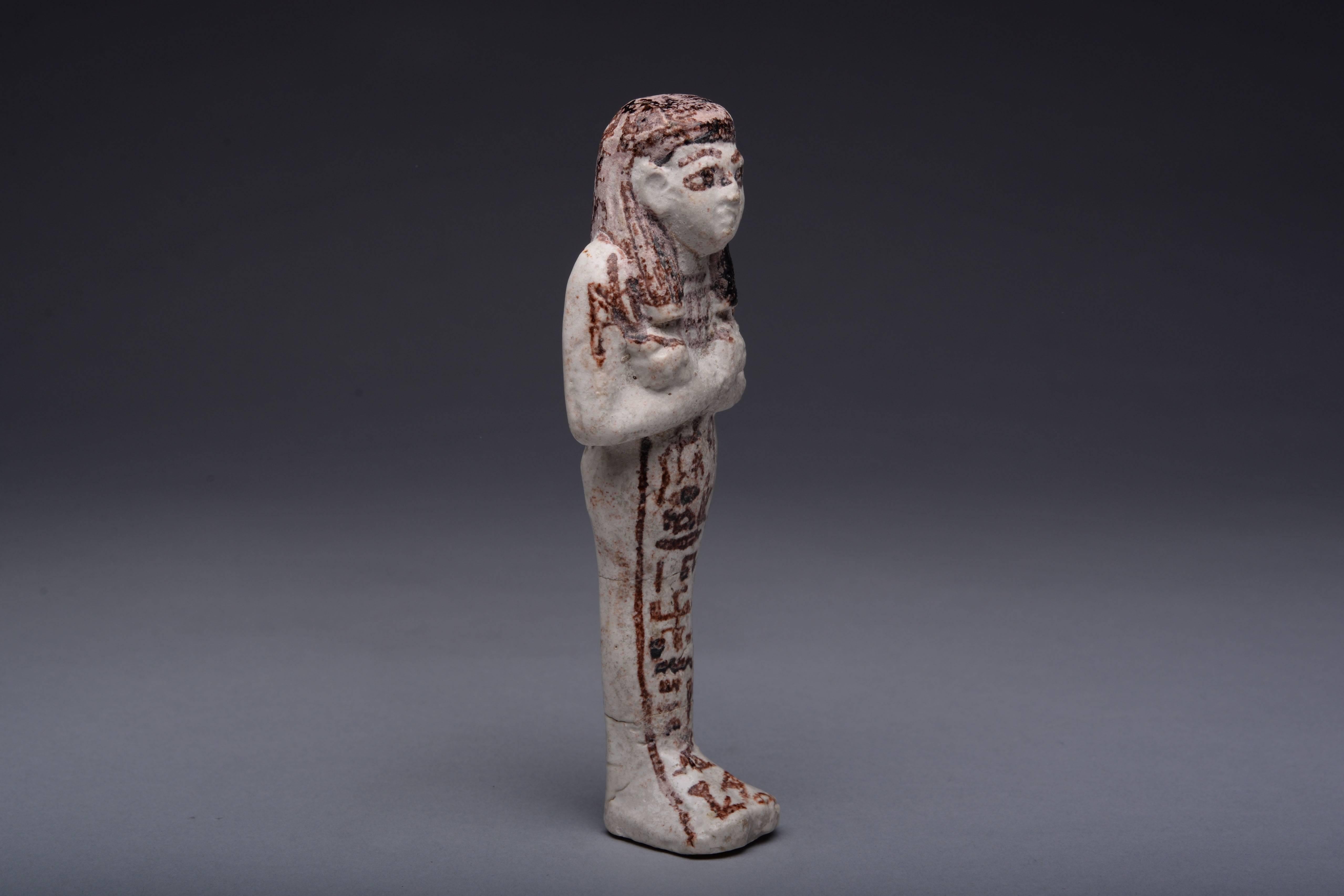 A very fine, rare and well preserved New Kingdom white faience shabti, dating to the 19th Dynasty, circa 1292 - 1187 BC. The figure modelled in beautiful and rare white faience, depicted mummiform with details added in purple-black. She is shown