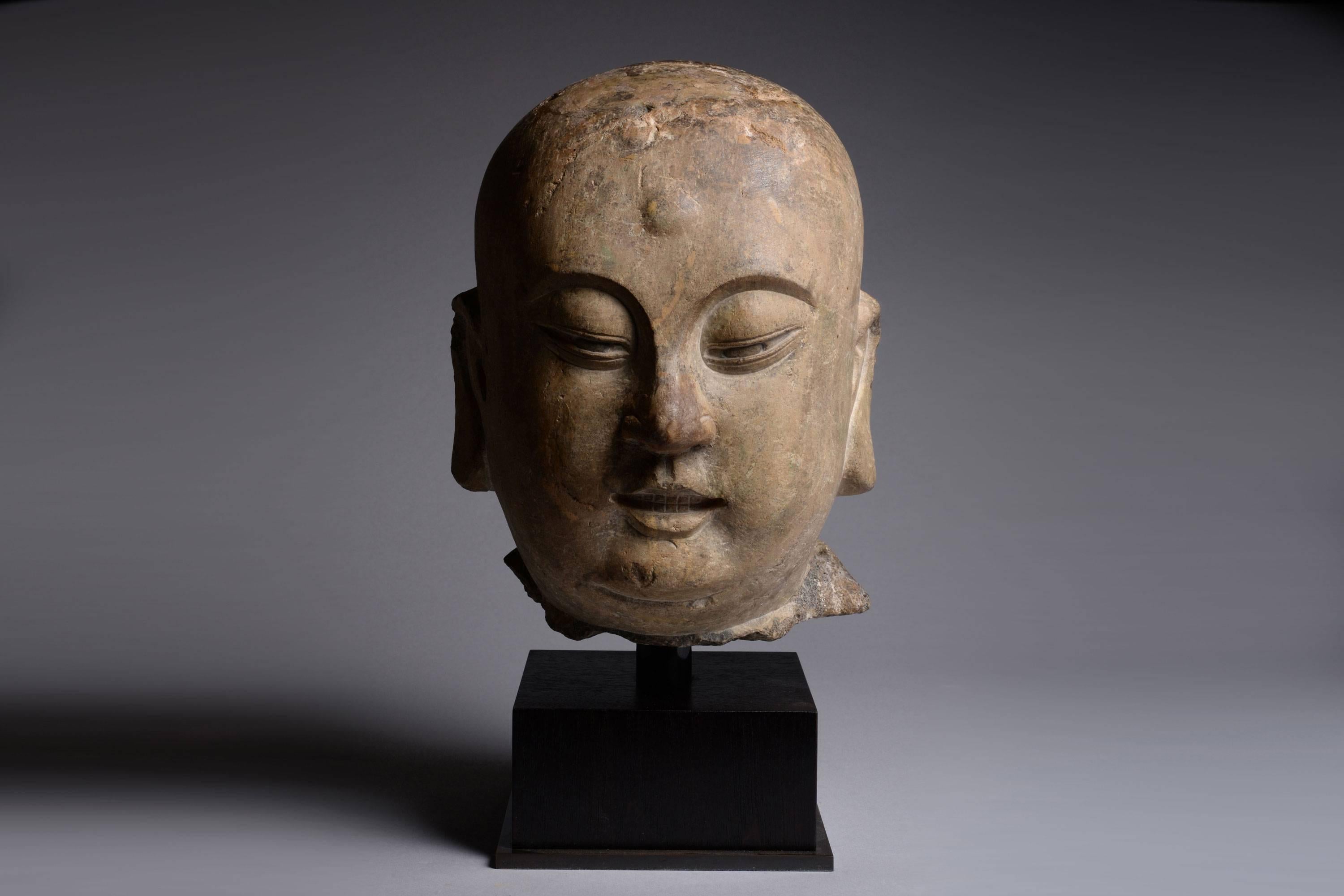 An ancient Chinese limestone sculpture, depicting the head of a lohan. Dating to China's Song Dynasty, circa 960 AD.

China’s adoption of Buddhism has resulted in some of the most spectacular sculpture in the world. In Buddhist teachings a lohan