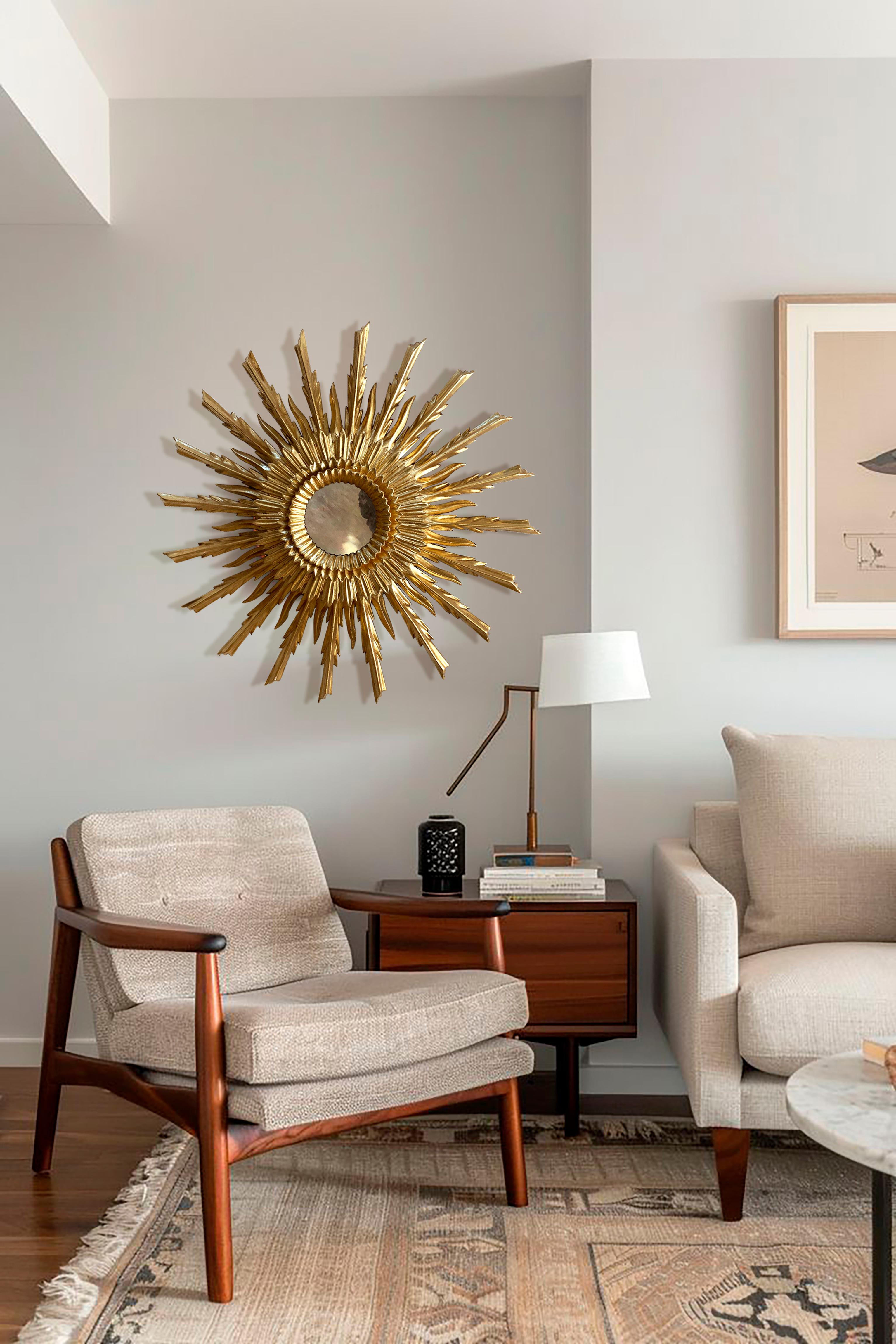 Amazing handcrafted golden mirror. This stunning piece is a true example of artisanal craftsmanship. It features multiple levels of gilded wooden rays arranged in a sunburst design, along with two uniquely styled concentric rings that elegantly