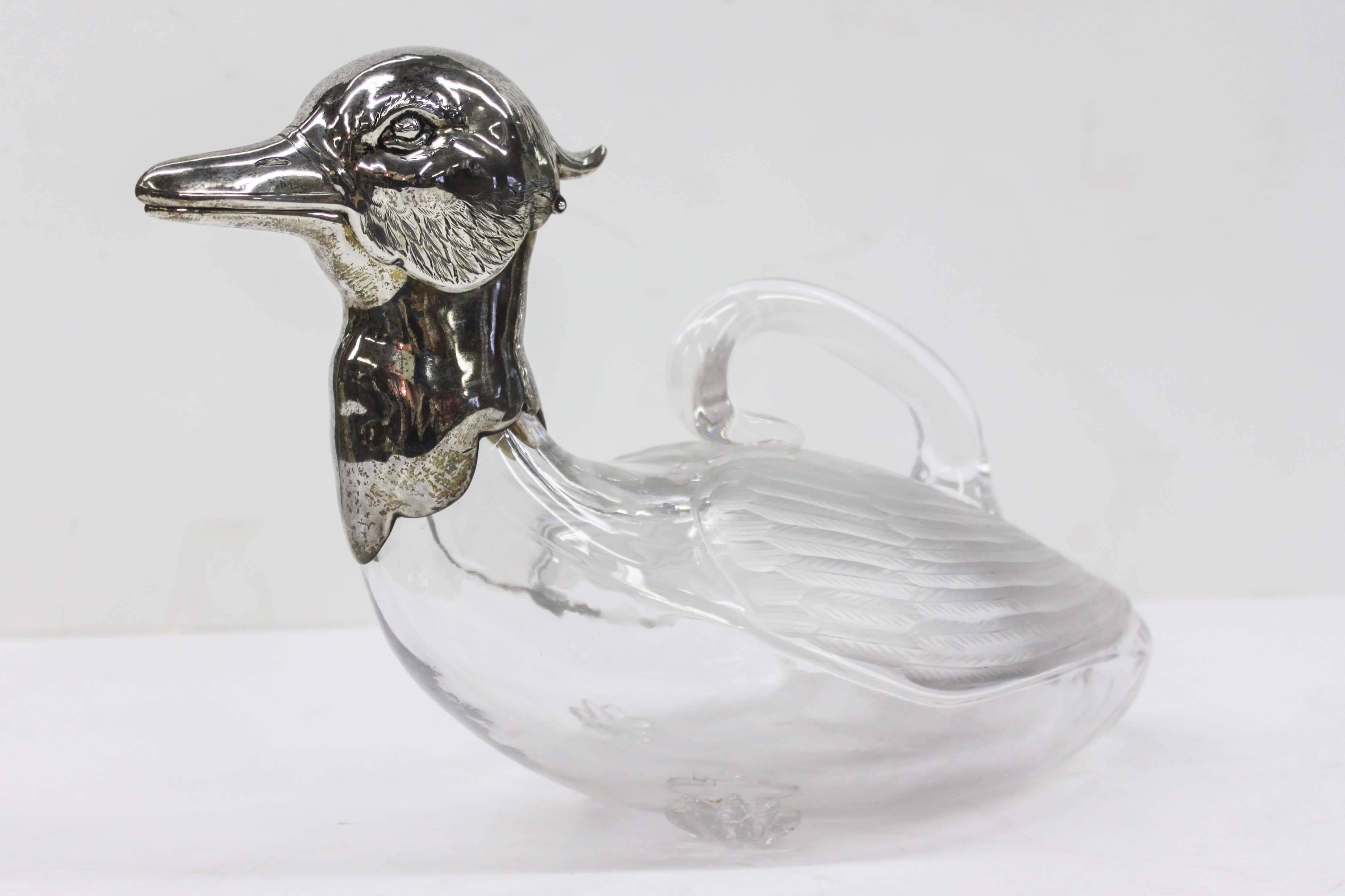 A rare early American crystal and sterling silver duck claret jug. Engraved silver head with cut crystal body, feet and formed handle. Beautiful original condition, no cracks or breaks in body, very heavy.