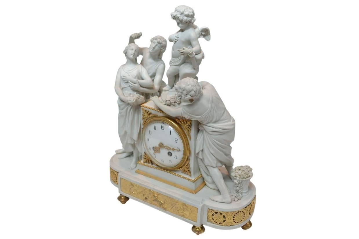 A biscuit porcelain clock by Sèvres, Paris, circa 1850, exhibiting an allegorical group of three young figures in classical drapery and a winged cupid with his quiver and a basket of roses. The stepped clock case is adorned with gilded bronze