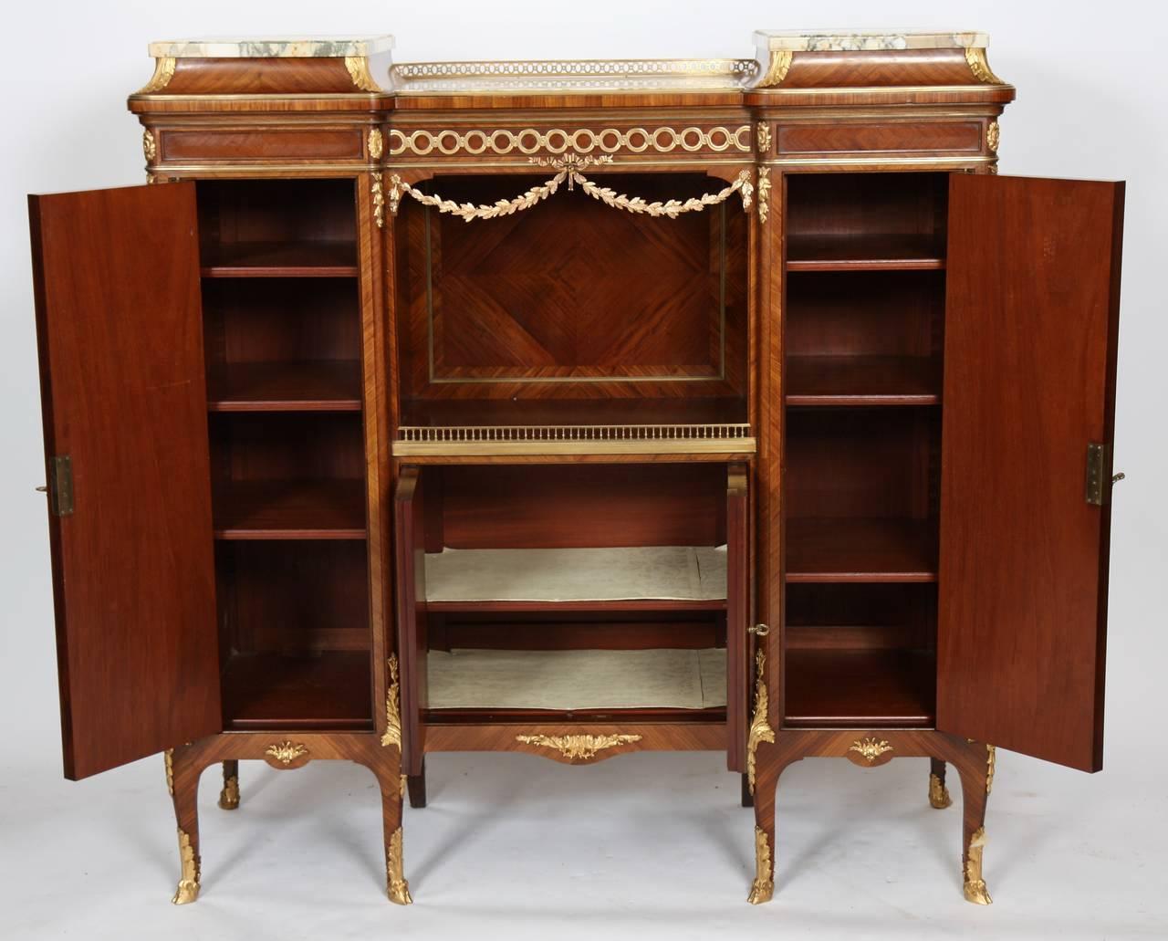 A Louis XV-style inlaid music cabinet by François Linke, a renowned Parisian ébéniste during the late 19th and early 20th centuries.

The cabinet is comprised of three sections, a center section with lower "tambour" doors which open