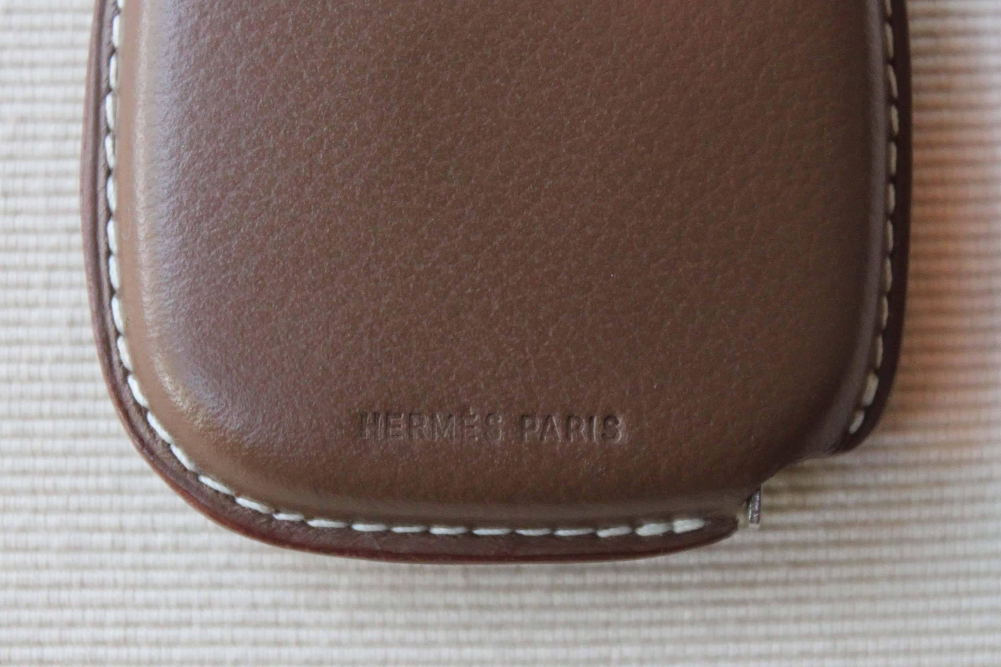 A vintage Hermès Leather encapsulated tape measure with white stitching. The tape is very thin, about 6 mm and extending to three metres, it slips easily into a jacket or pant pocket. A very sophisticated and stylish way to take measurements.