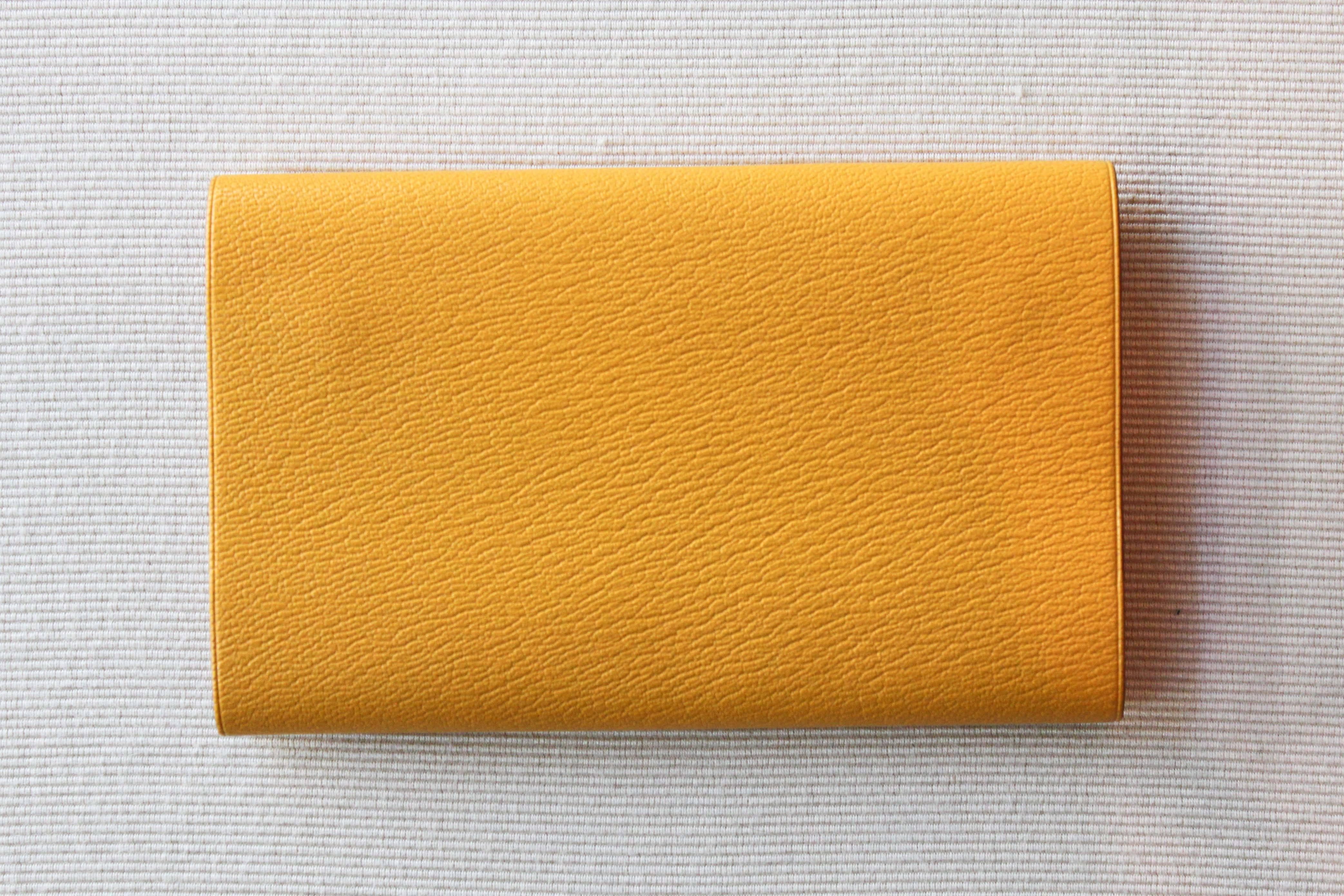 Vintage Hermès leather folio in bright yellow. Open on either side, stamped with an 