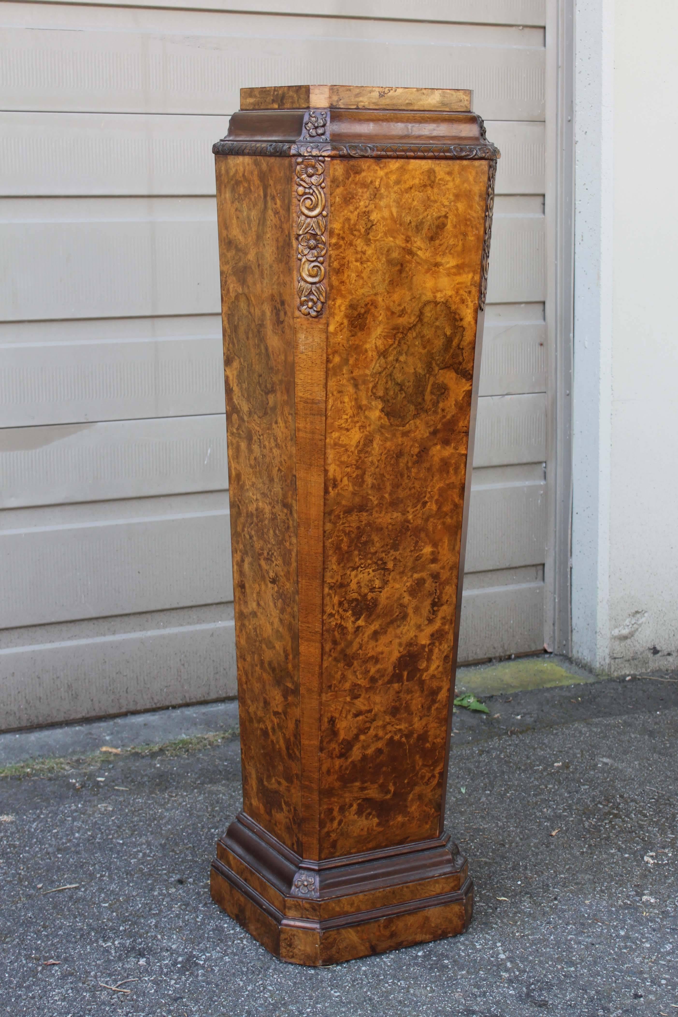Pair of columns with burled walnut veneer and carved details.
