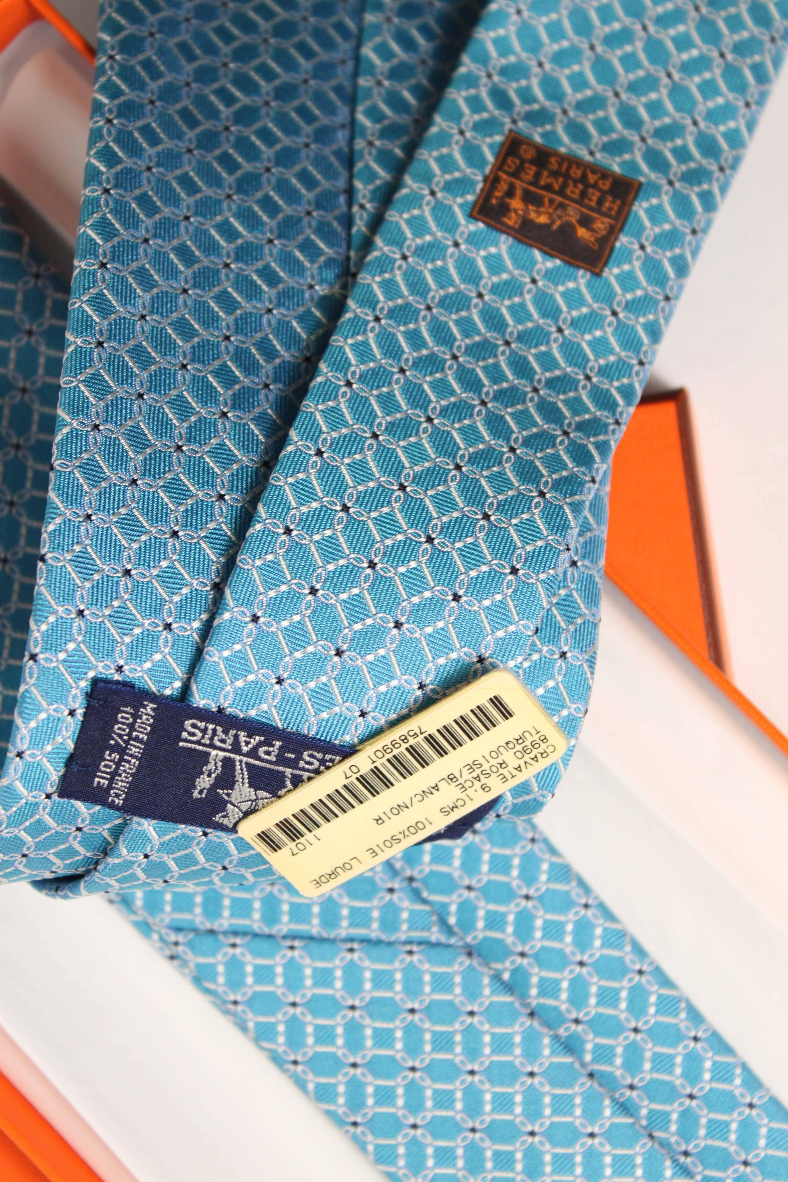 White over turquoise silk tie by Hermès. Like new condition with original tag and box, never worn. 