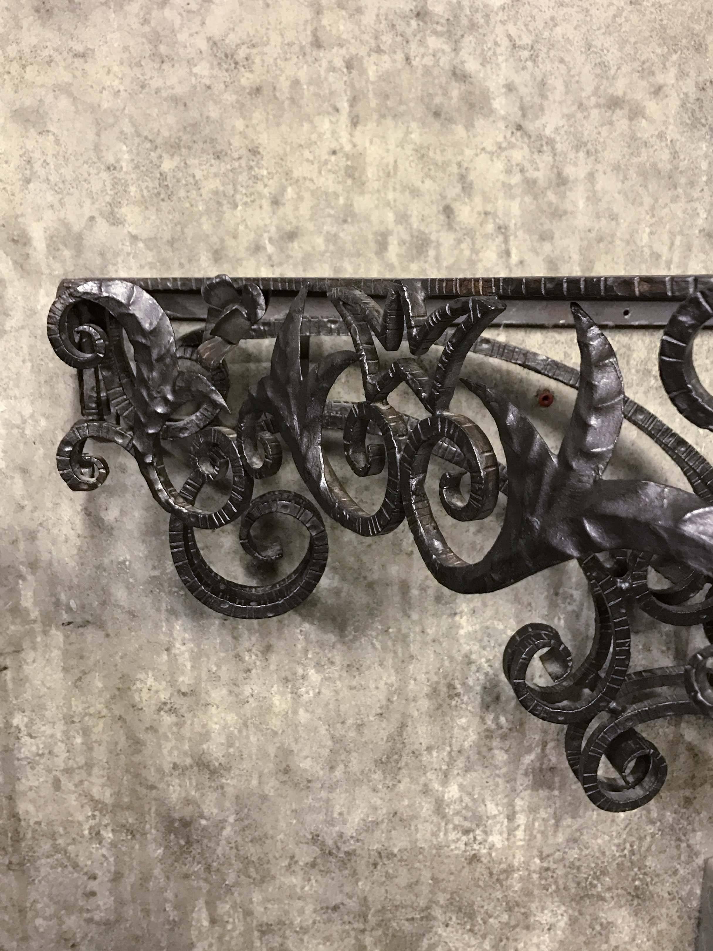 Console table with wrought iron base and marble-top.