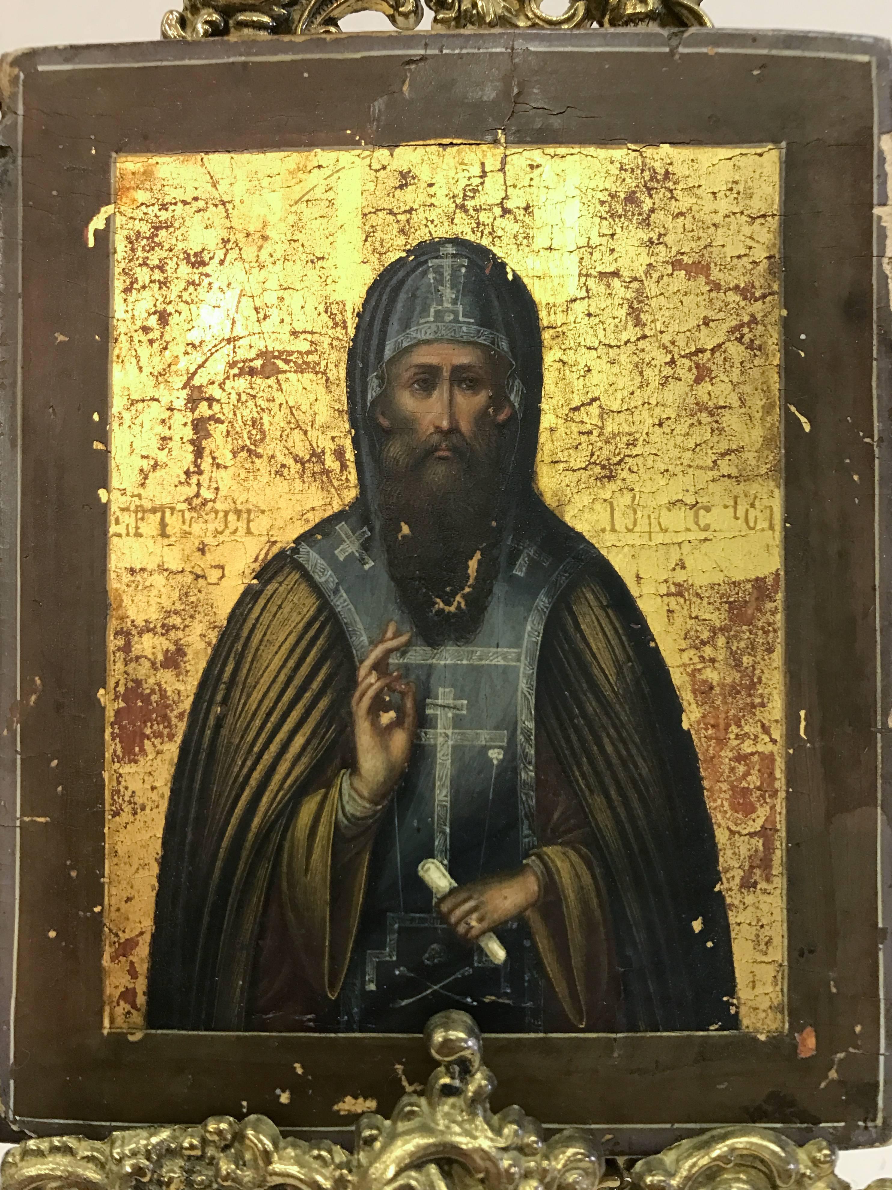 Russian icon painted on board with brass stand. Stand is not period but in the style of very good condition considering age, see photos.